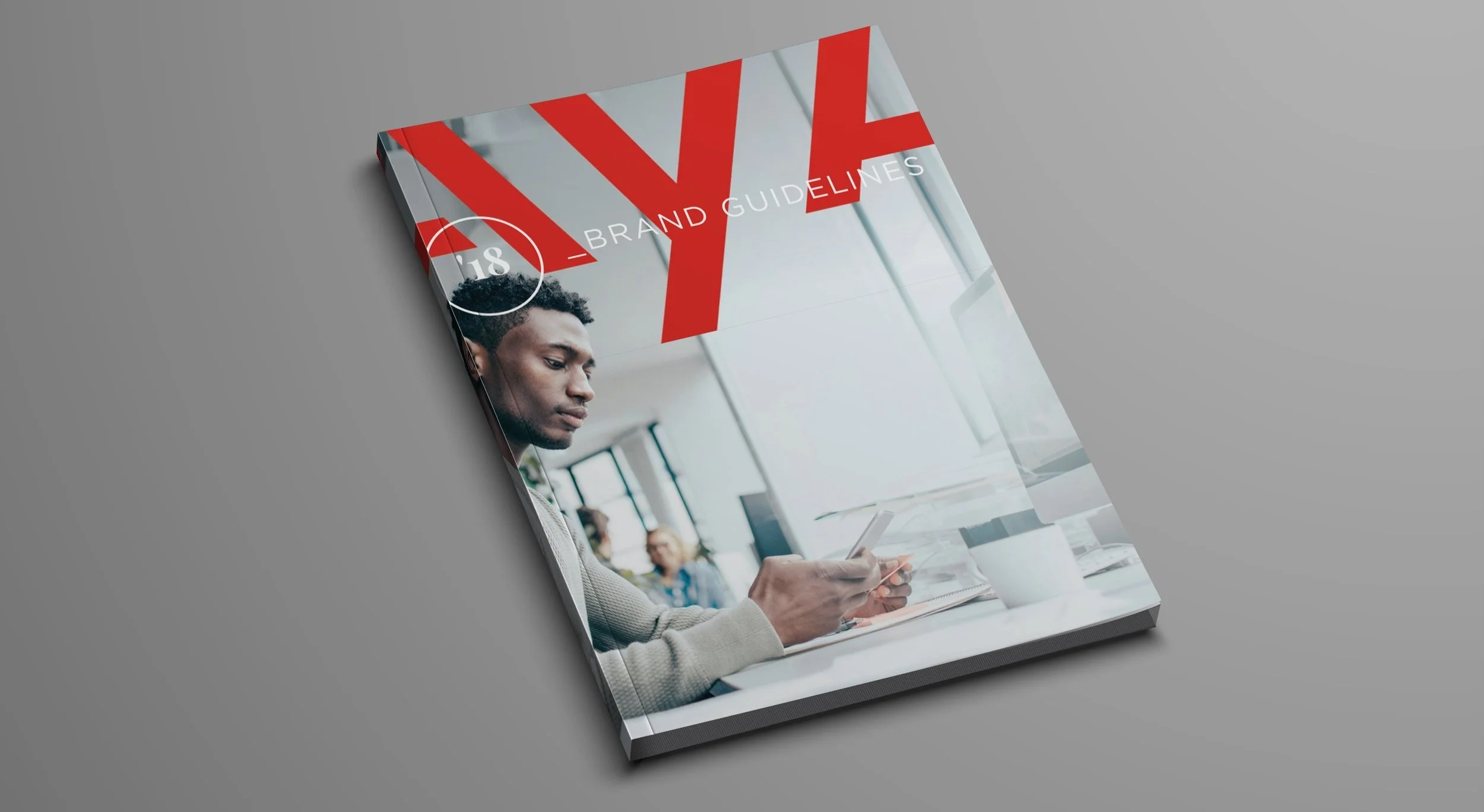 Cover of a brand guide titled 'VYNE Brand Guidelines' with a photo of a man looking at his phone in an office setting.