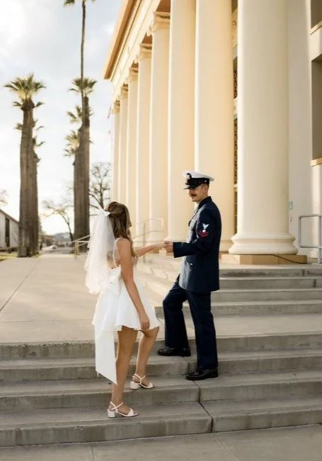 Short ivory veil with bow worn by a bride-to-be.