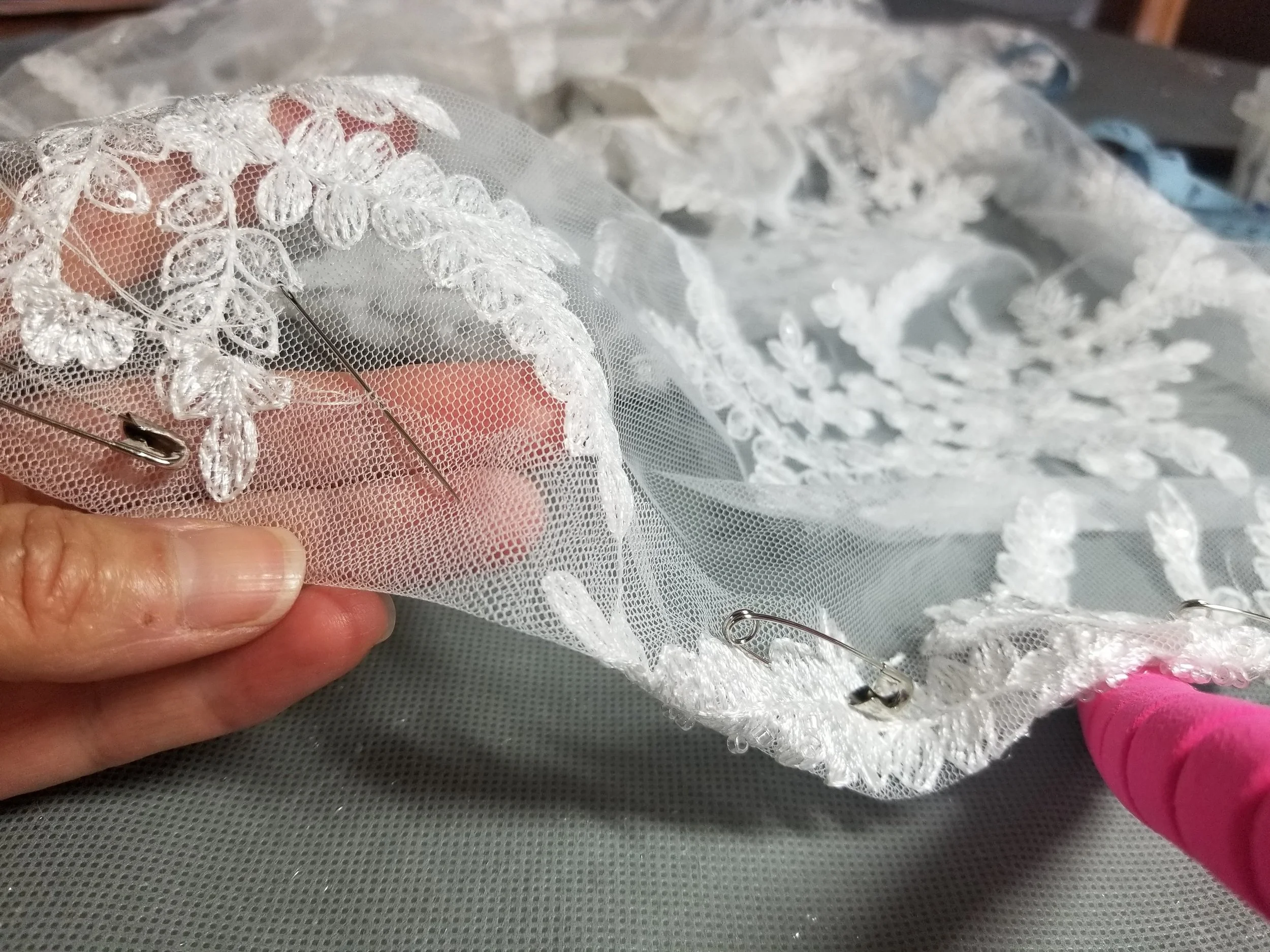 Hand stitch beading sewn on a wedding day cover up.