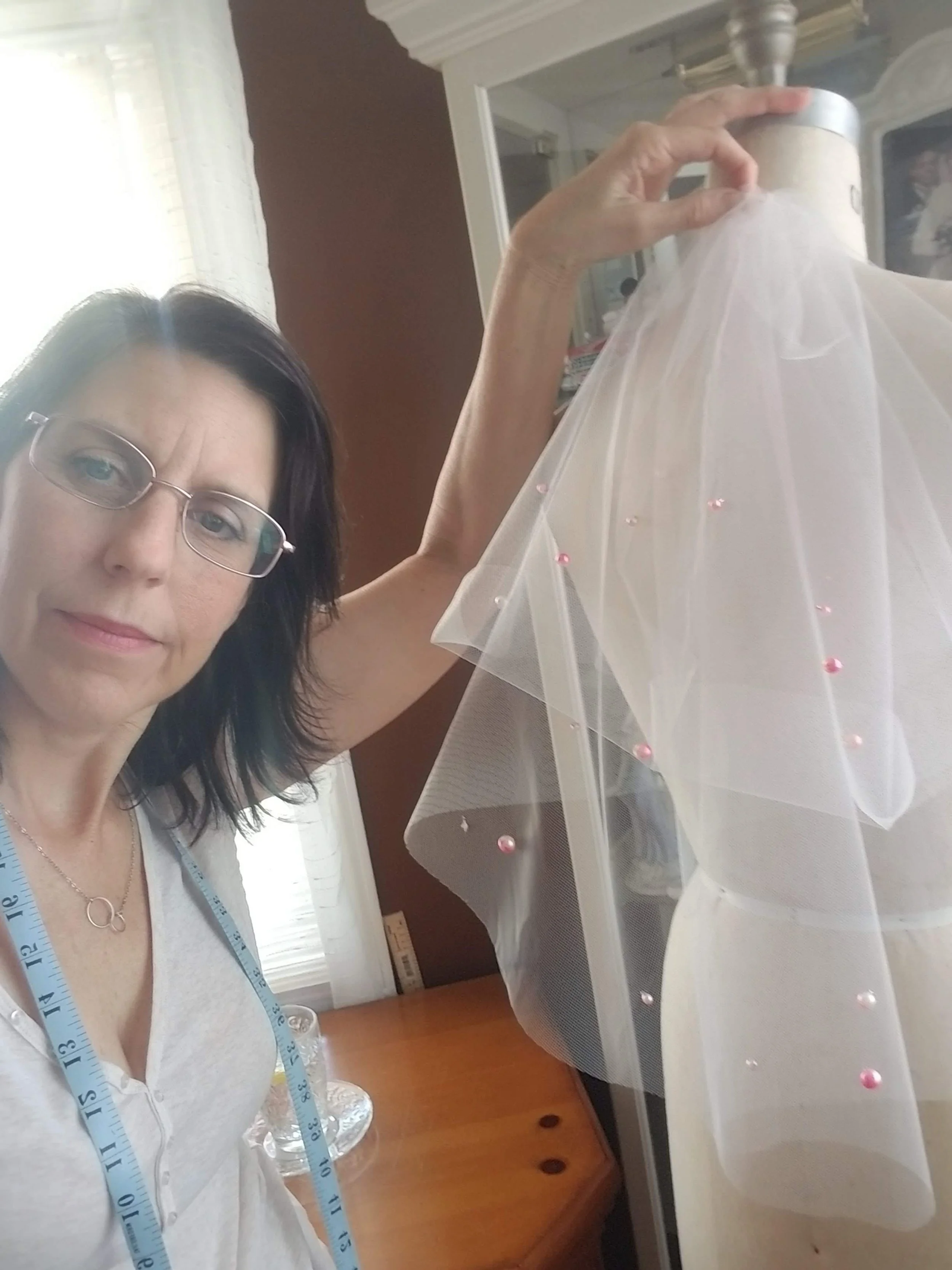 Veil Designer creating a custom short veil with pearls