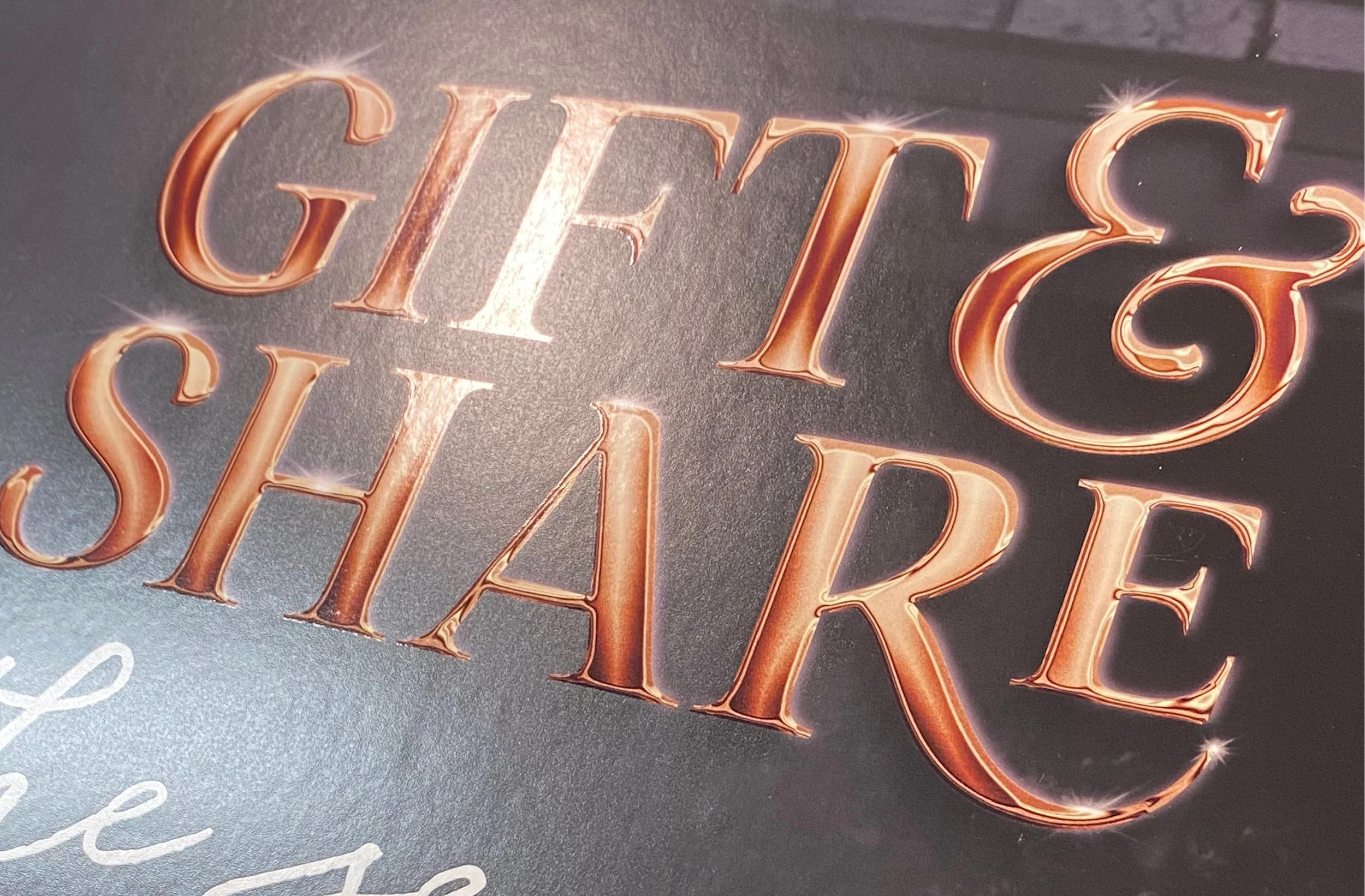 Close-up of In-store Collateral: Gloss varnish treatment over text enhanced the metallic look.