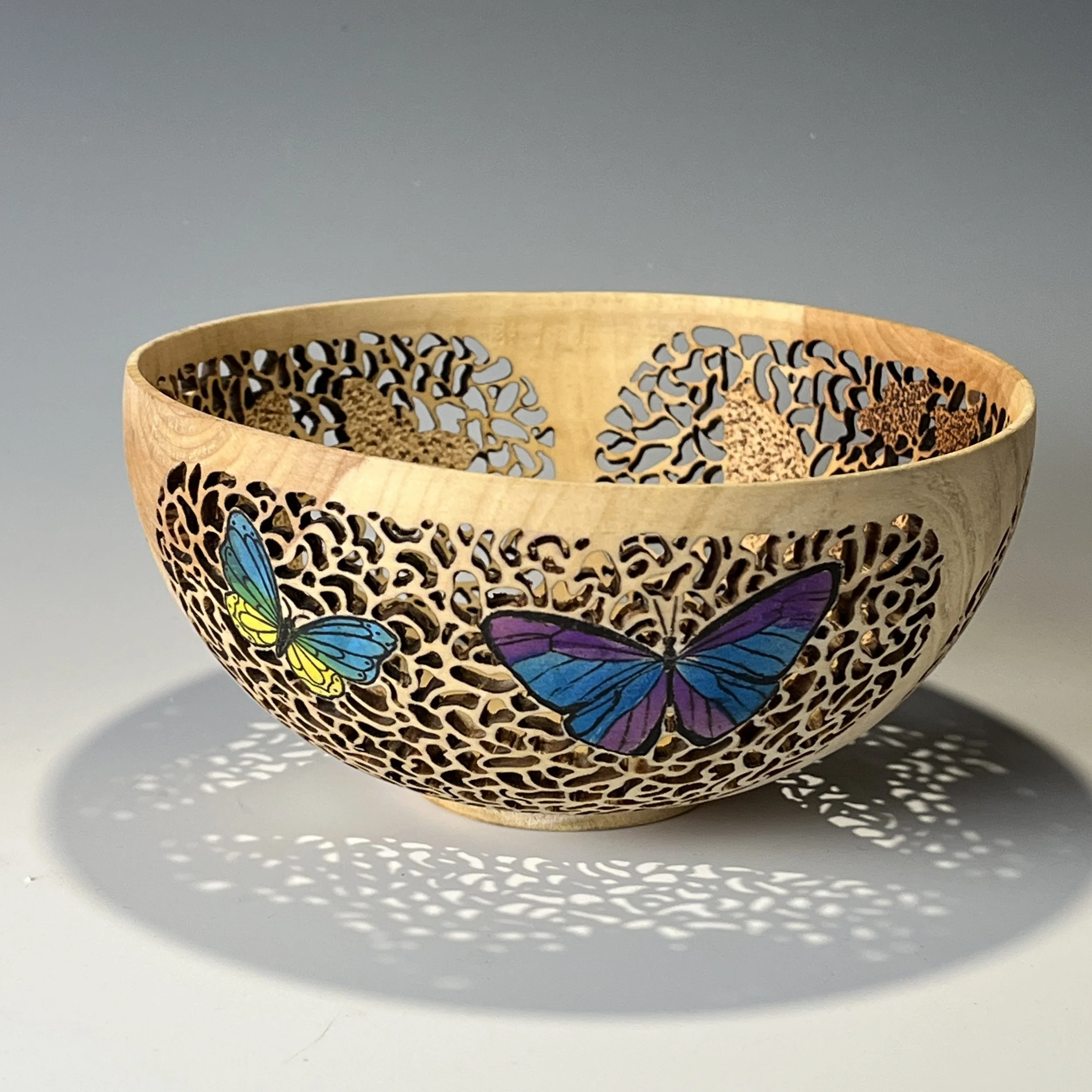 Butterflies.  Maple.  Pierced, airbrushed.  5.5" x 2.5". 2026.12.