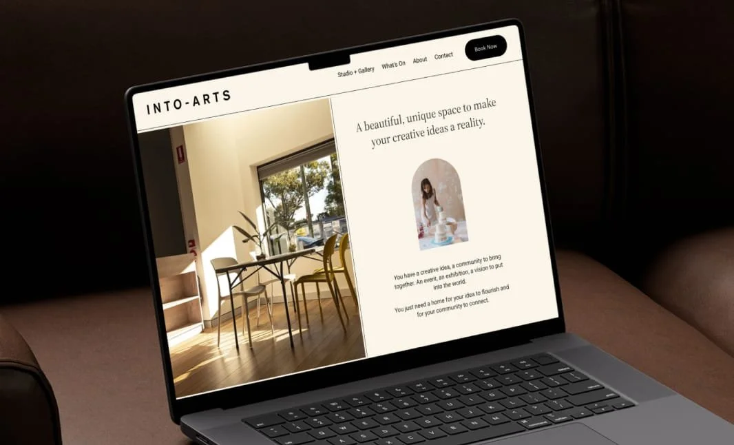A laptop showing the Into-Arts website