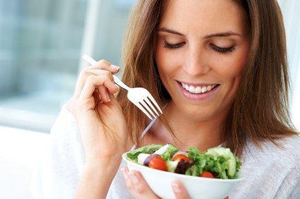 woman eating a salad with a fork
