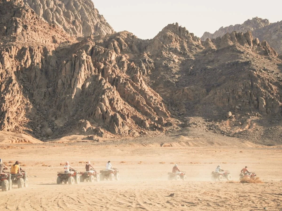 activities in Sharm El Sheikh inlcude ATV bikes in the surrouning desert with rocky mountains in the back ground