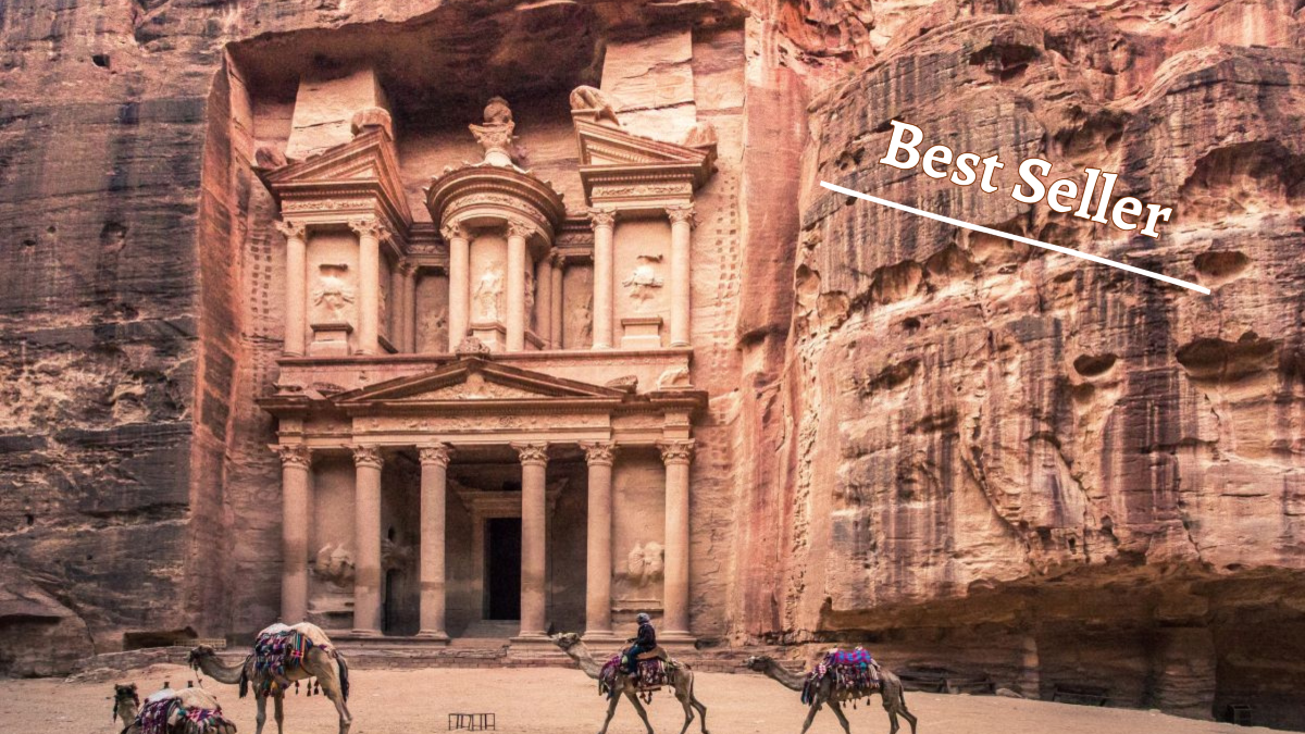 petra's famous treasurey shows camels in the forground with a rock carved temple on a towering facade