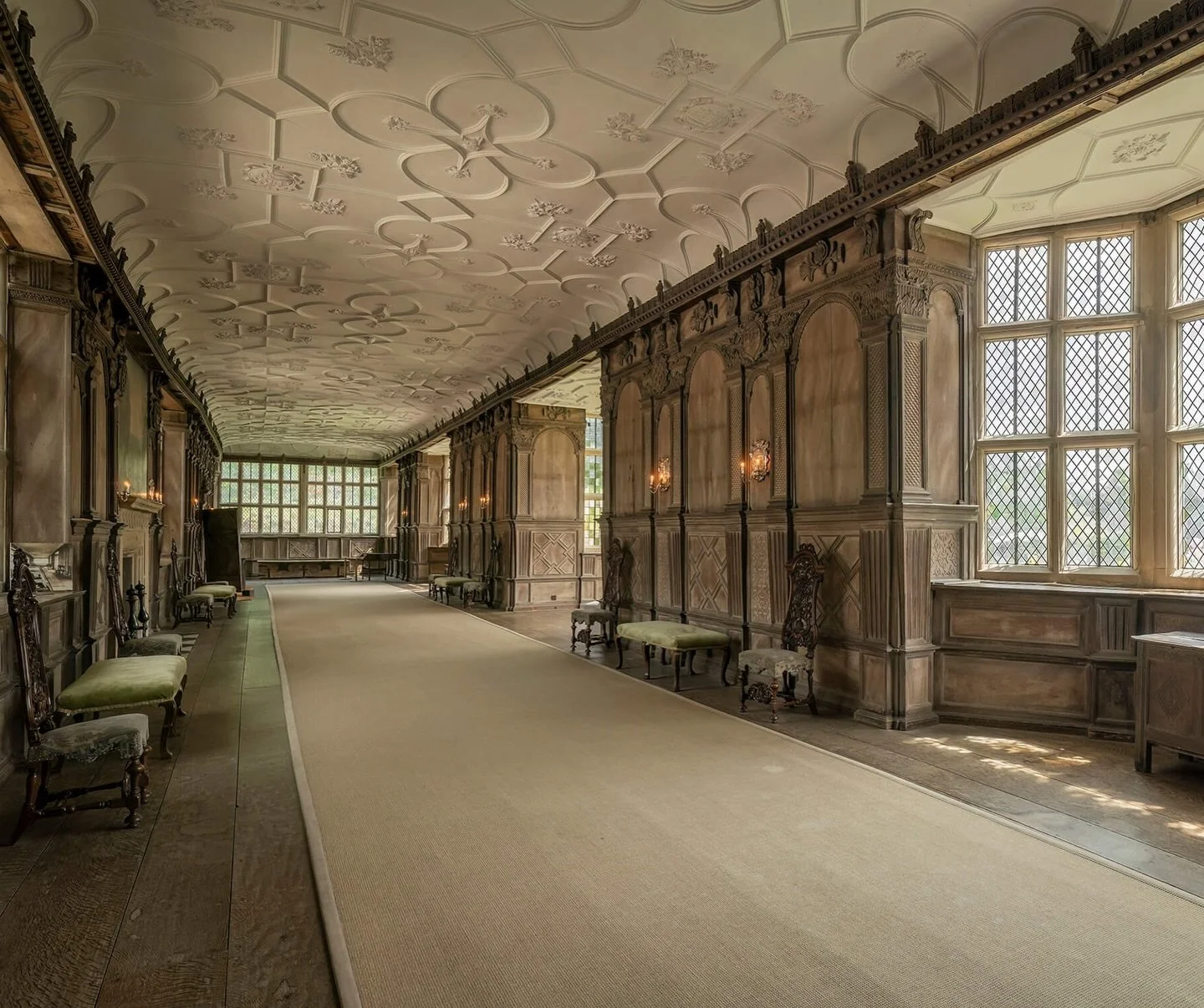 Photography of the Long Gallery at Haddon Hall, Derbyshire. This Elizabethan room is a breathtaking 110ft-long and widely considered one of the most beautiful in England. Designed by Robert Smythson, it features original 16th-century bomb&eacute; gla