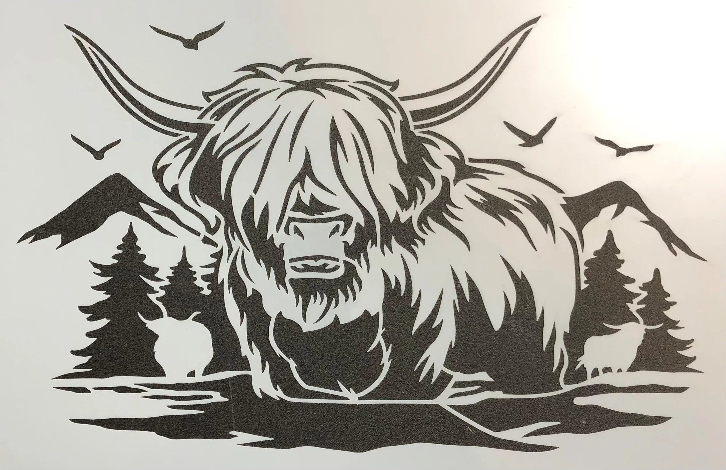 Silhouette of a large, crouching yeti with long hair and horns, surrounded by mountains, trees, flying birds, and smaller animals like deer and wolves.