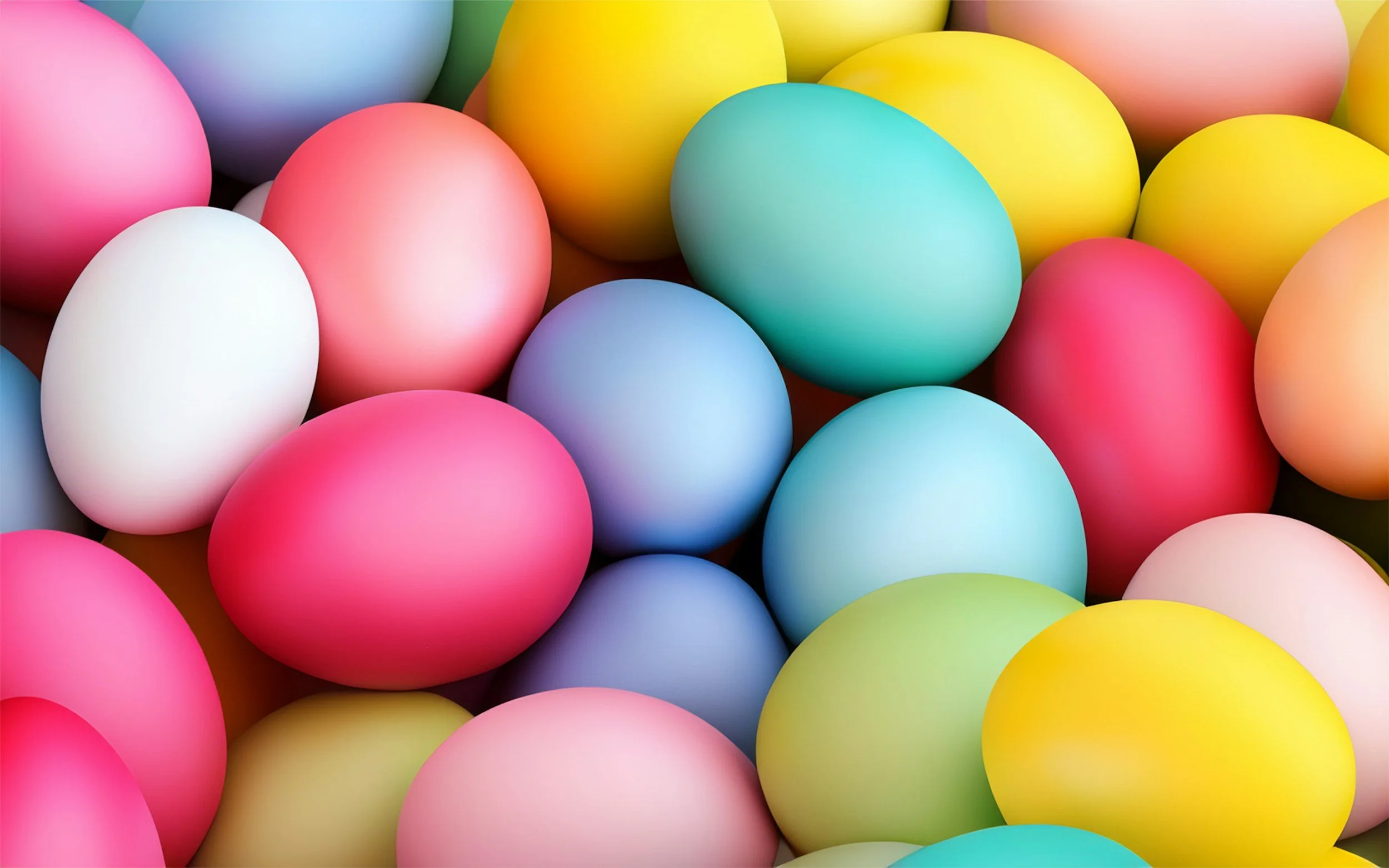 Multicolored plastic Easter eggs in pink, yellow, white, blue, green, and purple.