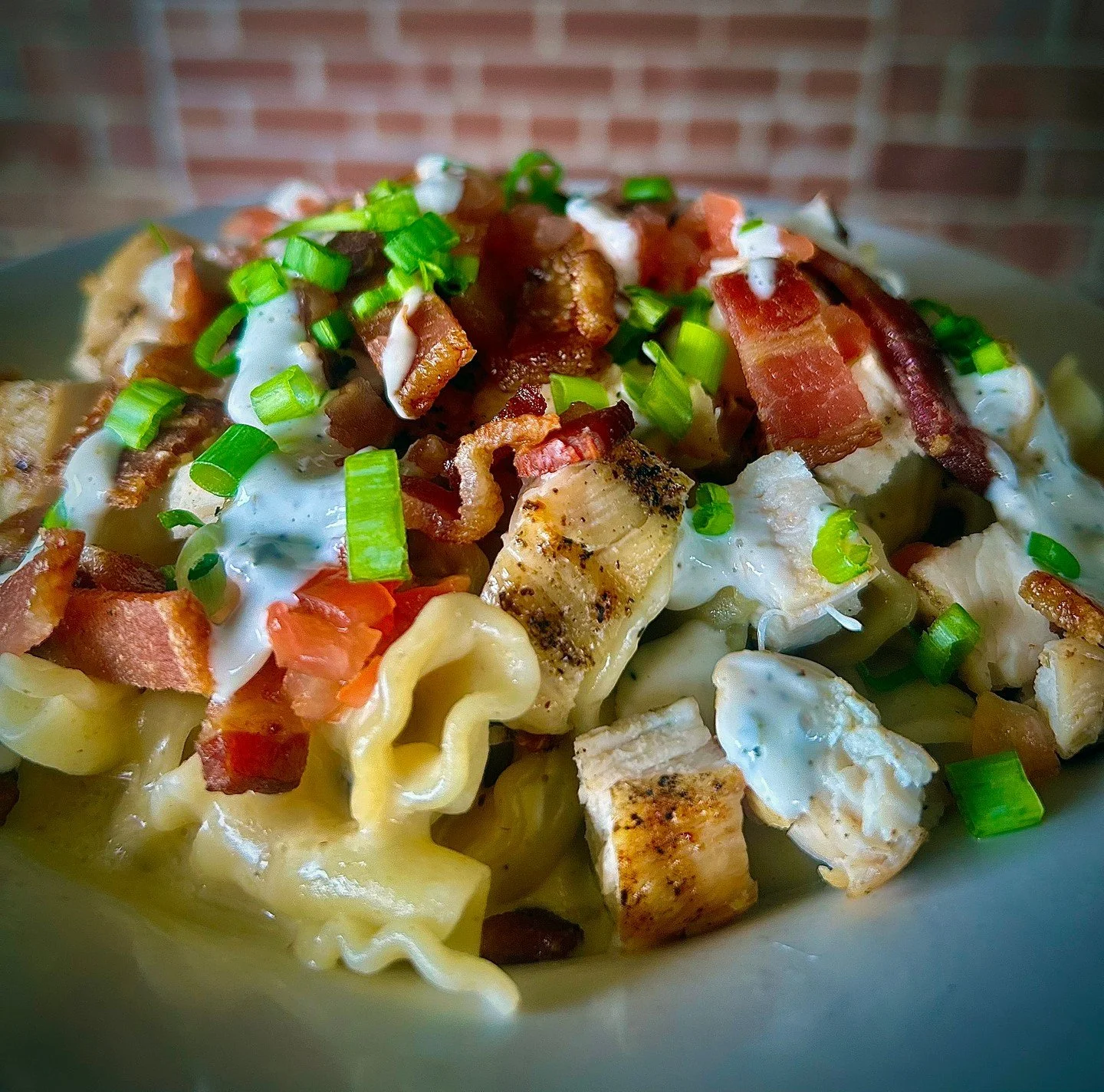 CHICKEN MAC: our original mac &amp; cheese with grilled chicken, bacon, tomato, green onion, and a drizzle of ranch. 

#TheCrowsNestSTL #MaplewoodMO #StLouisEats #MacAndCheese #ComfortFood #BarFood #NewMenu #ChickenMac