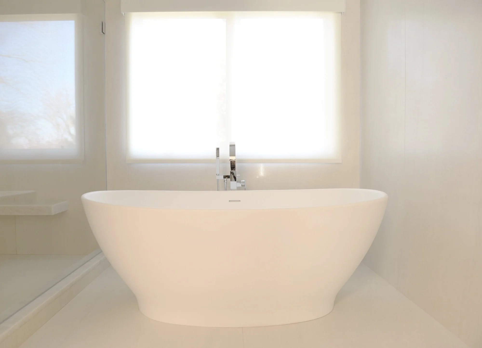 Freestanding tub below the window