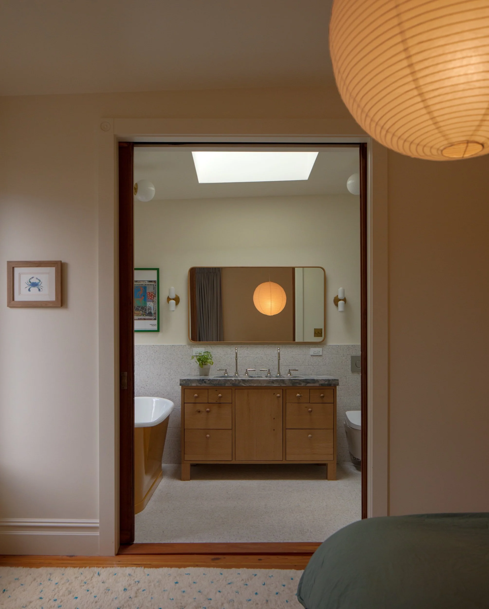 Primary bath seen through the bedroom doors