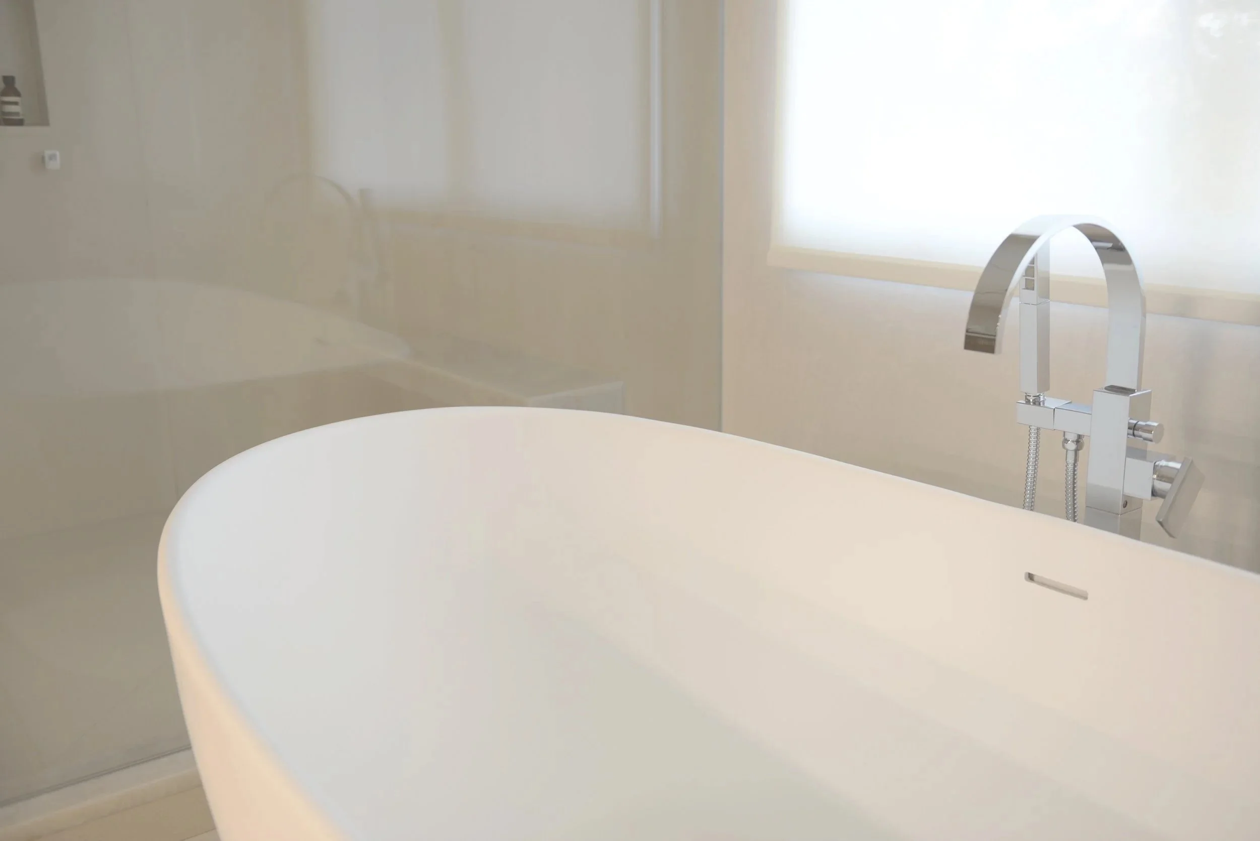 Primary bathroom with vanity and freestanding tub