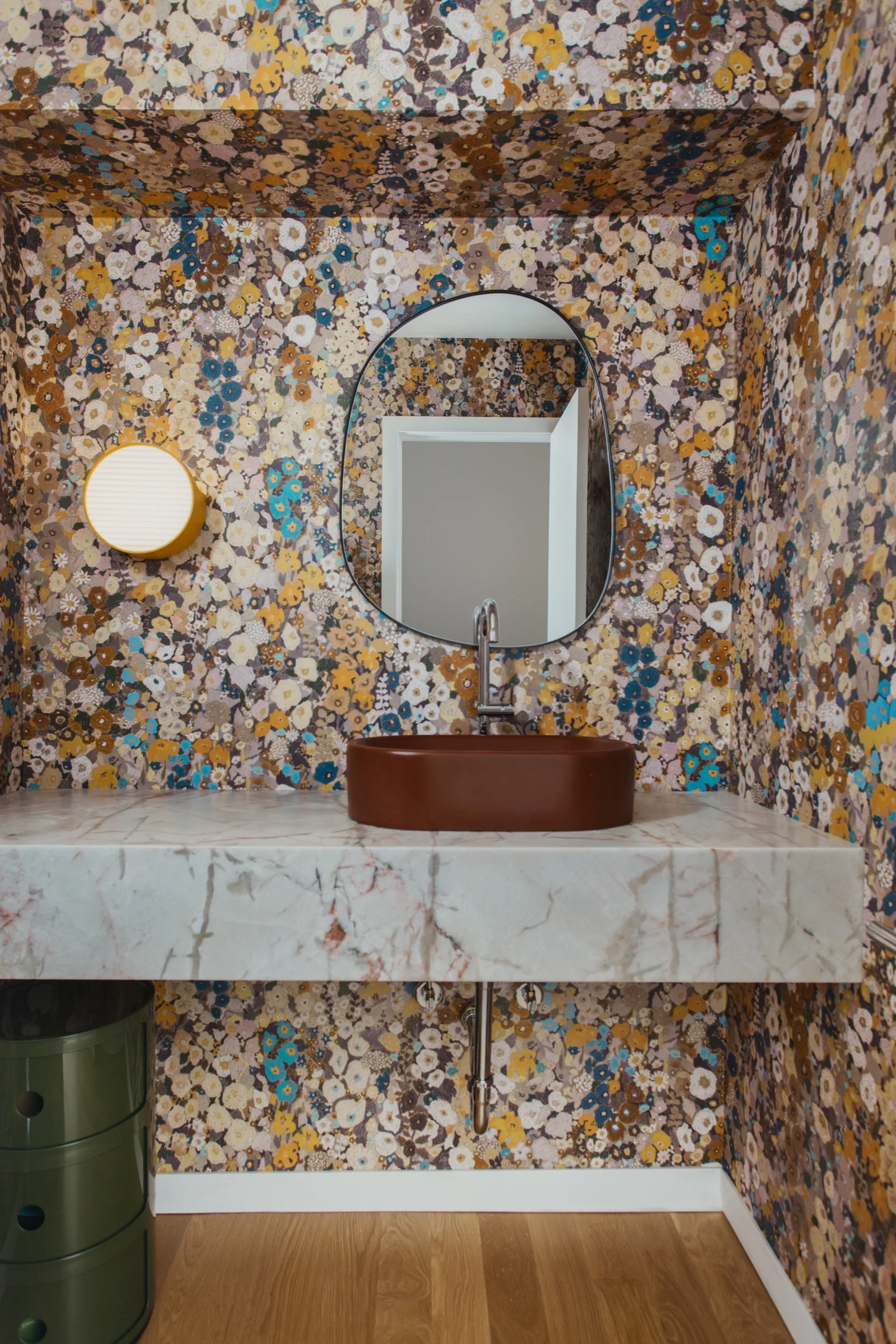 Powder room with botanical wallpaper