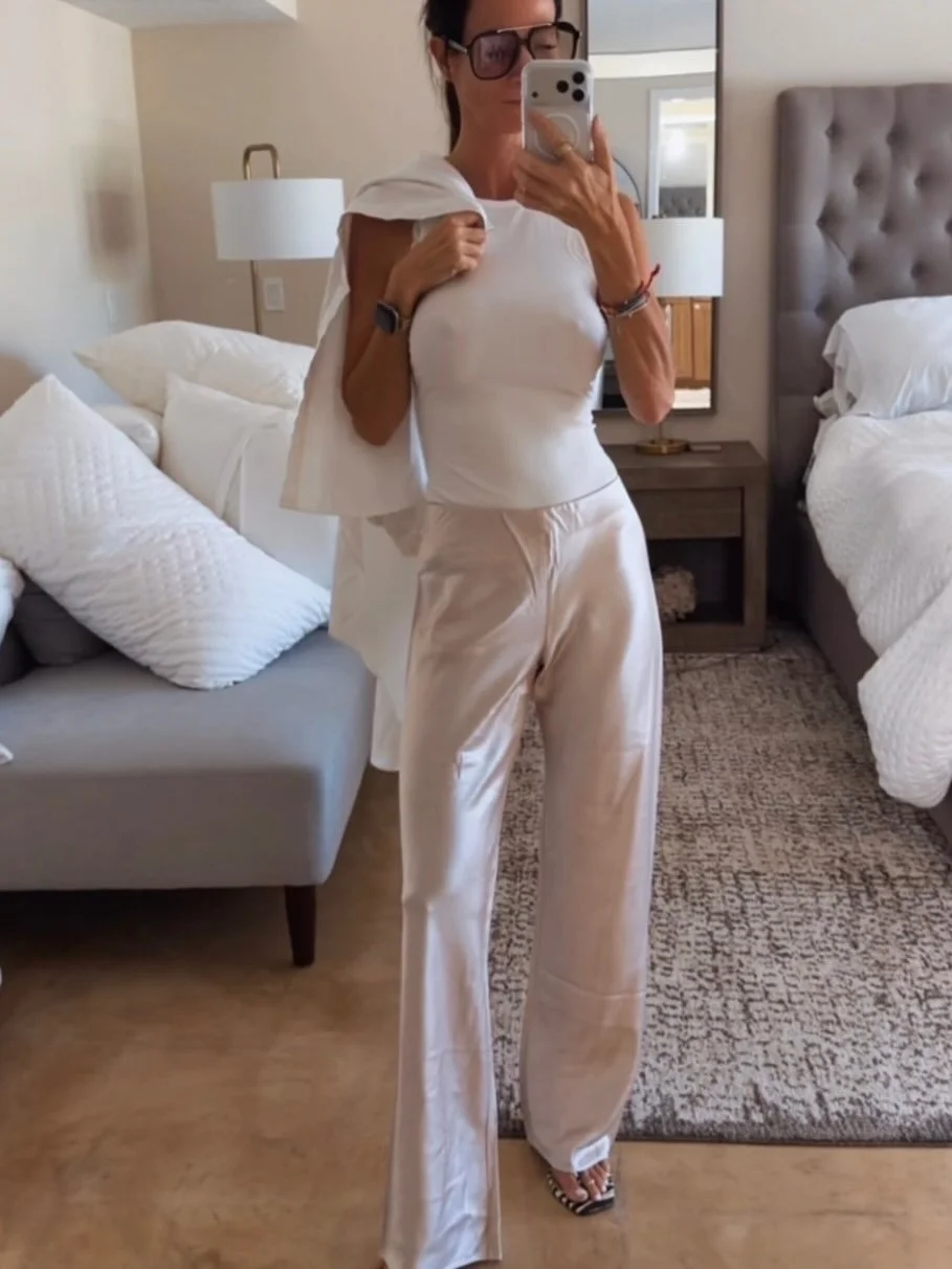 Consider this your reminder that satin pants do not require dinner reservations. 🤍✨

I actually love them MORE styled down.

A fitted white tank + silky satin pants + an oversized button-down thrown over the top = that slightly undone, I didn&rsquo;