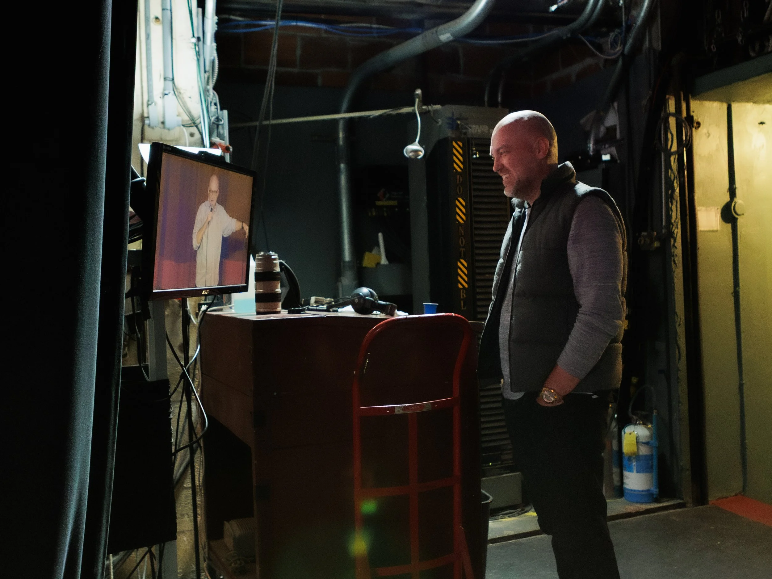 Cory Michaelis Watches Brad Upton on stage on the monitor 