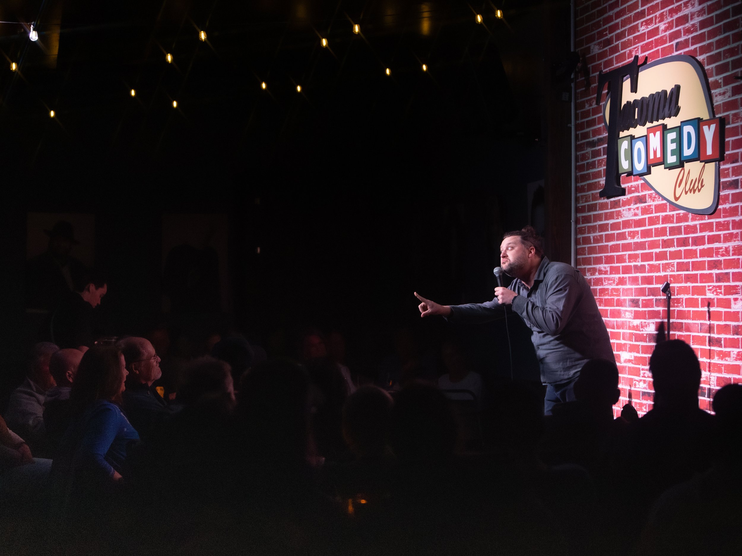 Mike Coletta, comedian, on stage, tacoma comedy club