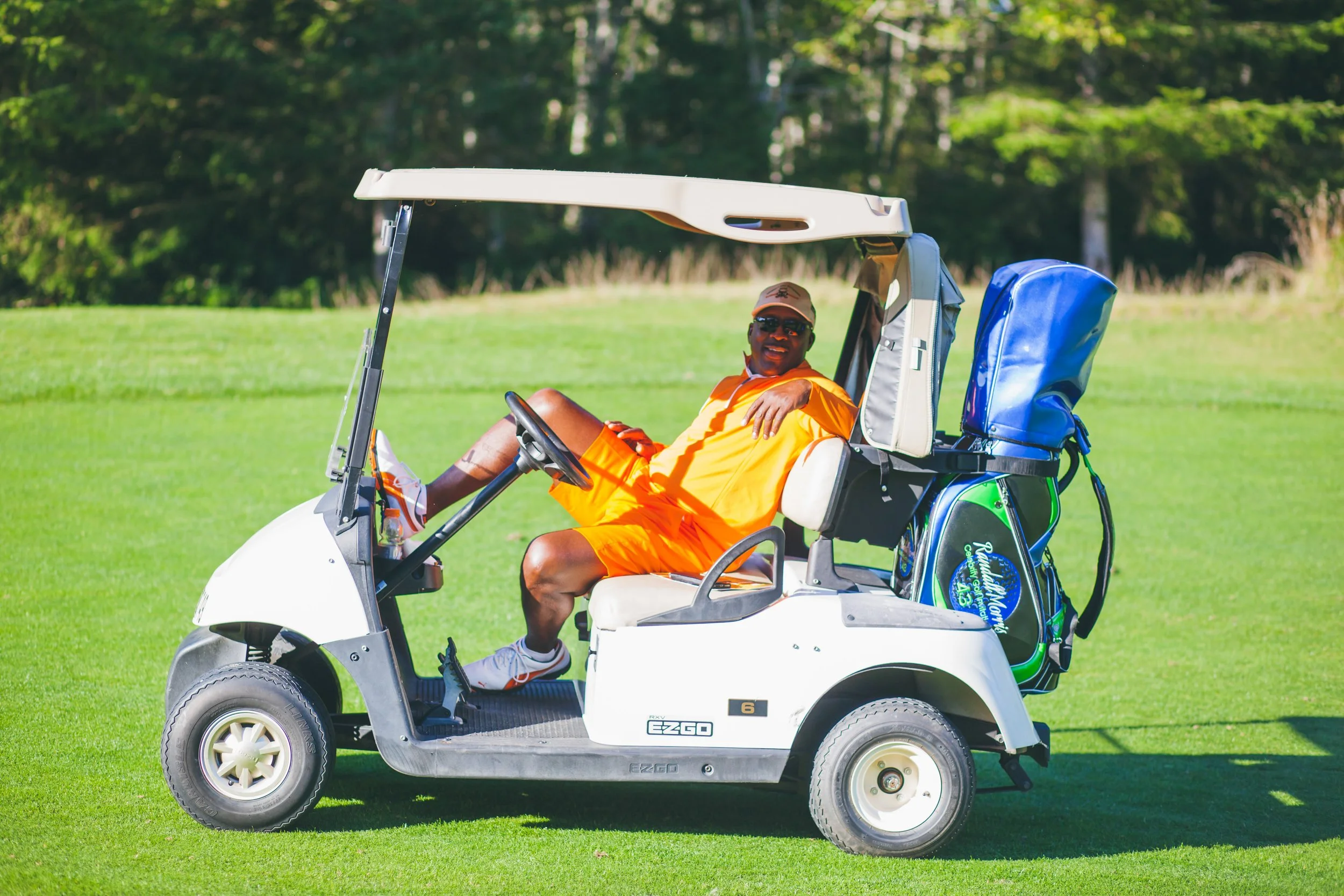 Randall Morris (too hard to handle Randall #43) who played for the seattle seahawks, lounging on a golf cart on the green at a golf course- at white horse golf course in kingston