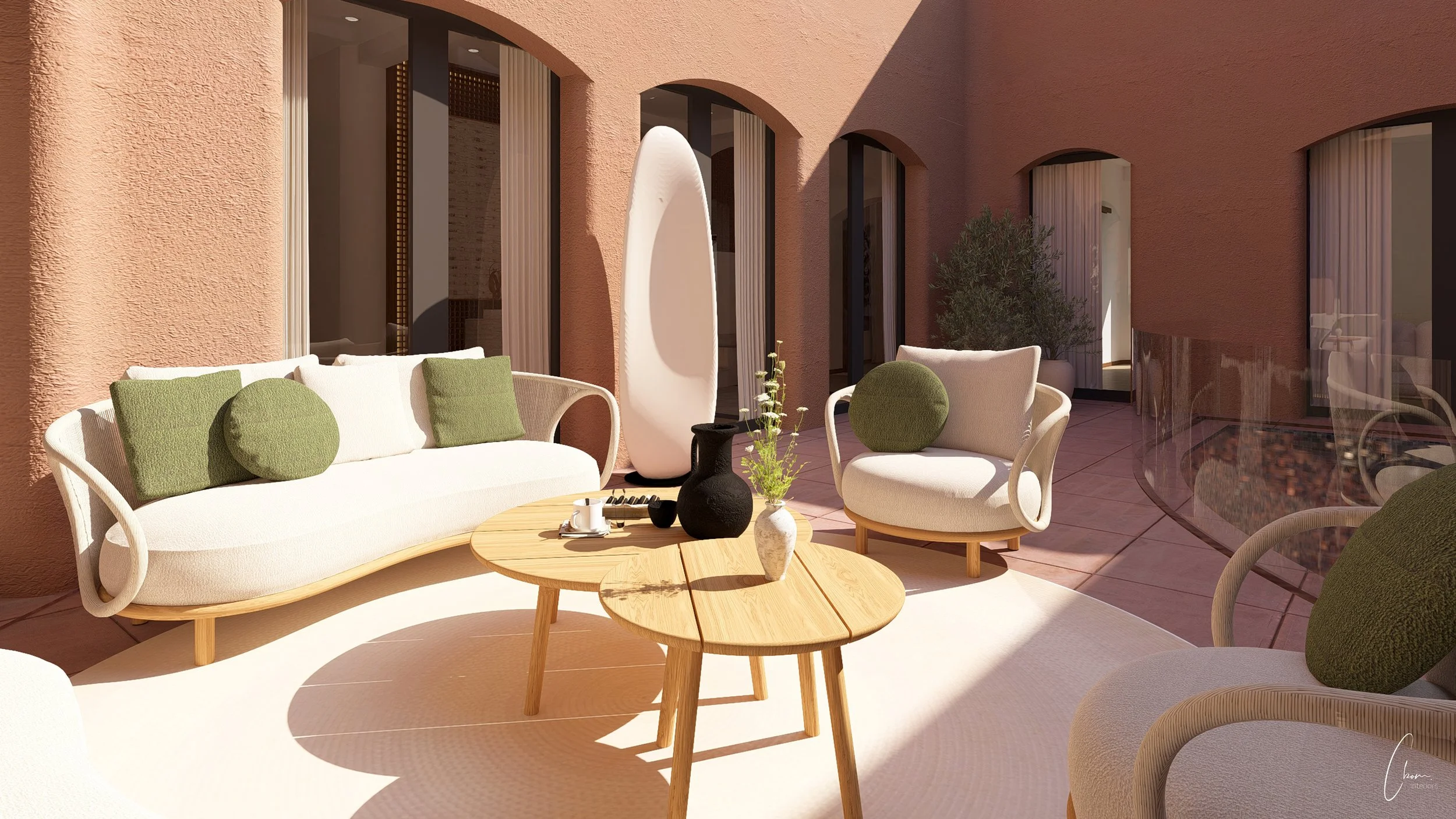 Espace détente extérieur ombragé, mobilier en rotin et coussins aux tons verts