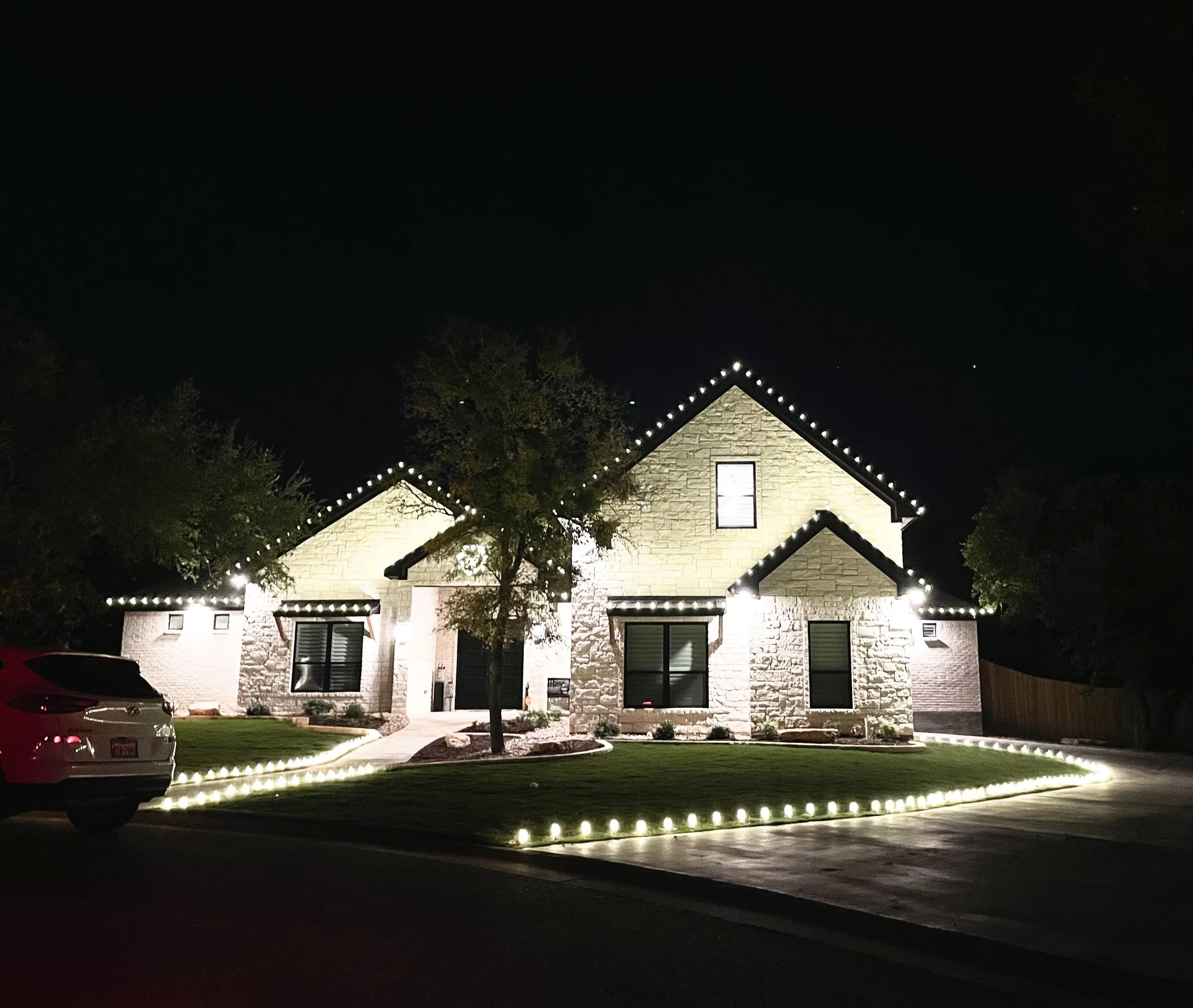 warm white christmas lights on a home and ground lights in killeen Texas