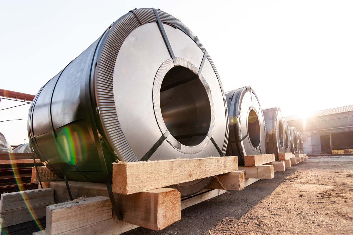 Large steel cylinders loaded on pallets with cribbing wood blocks