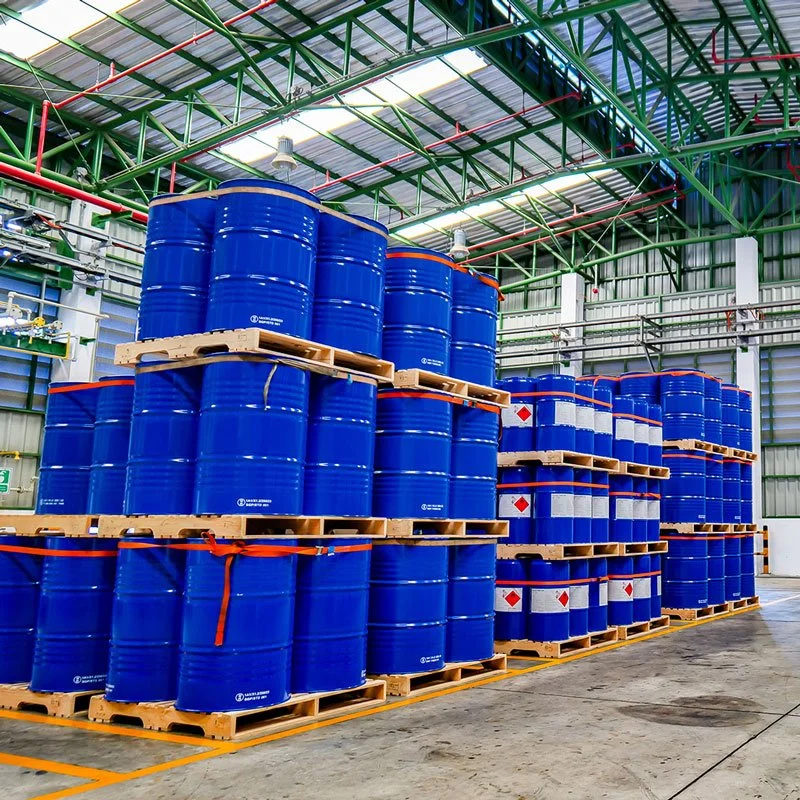 50 gallon blue drums stacked 3 high on pallets in a warehouse