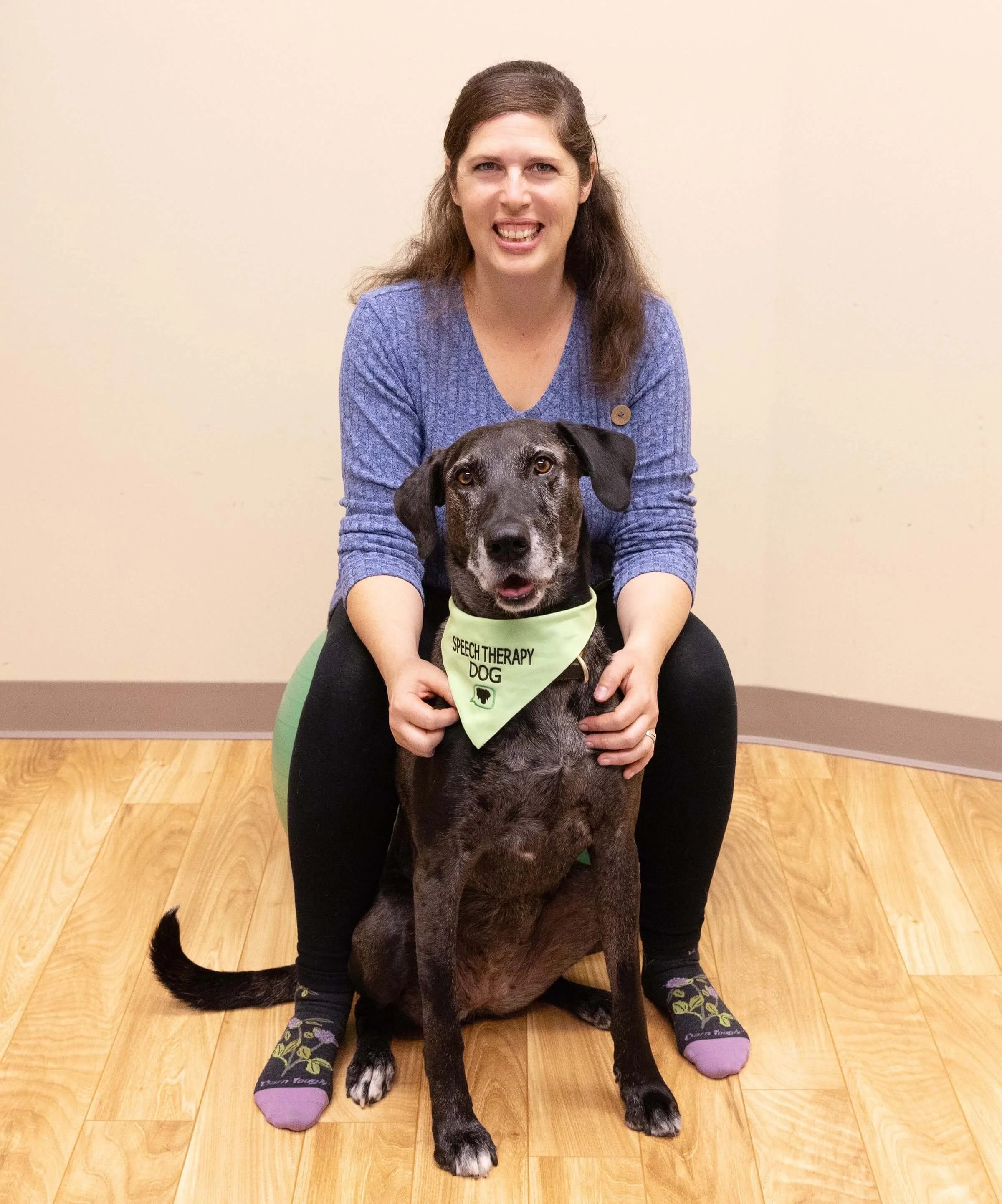 Canine-assisted speech therapy team Sharlet and Delta sit together.