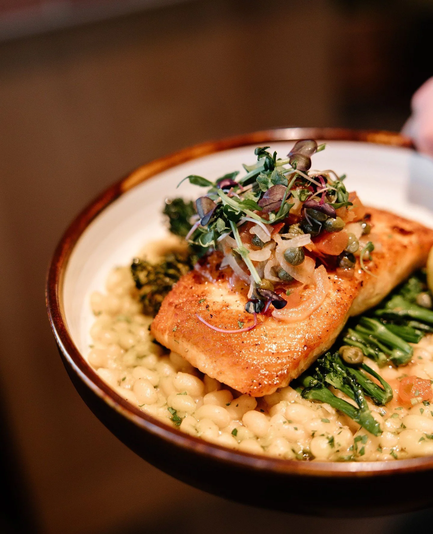 Local salmon, golden and crisp from the pan, nestled over cannellini beans, sauce vierge, and market vegetables. A thoughtful plate for an easy evening. 🐟🍷⁠
⁠
Reserve your table for dinner this evening at our link in bio.