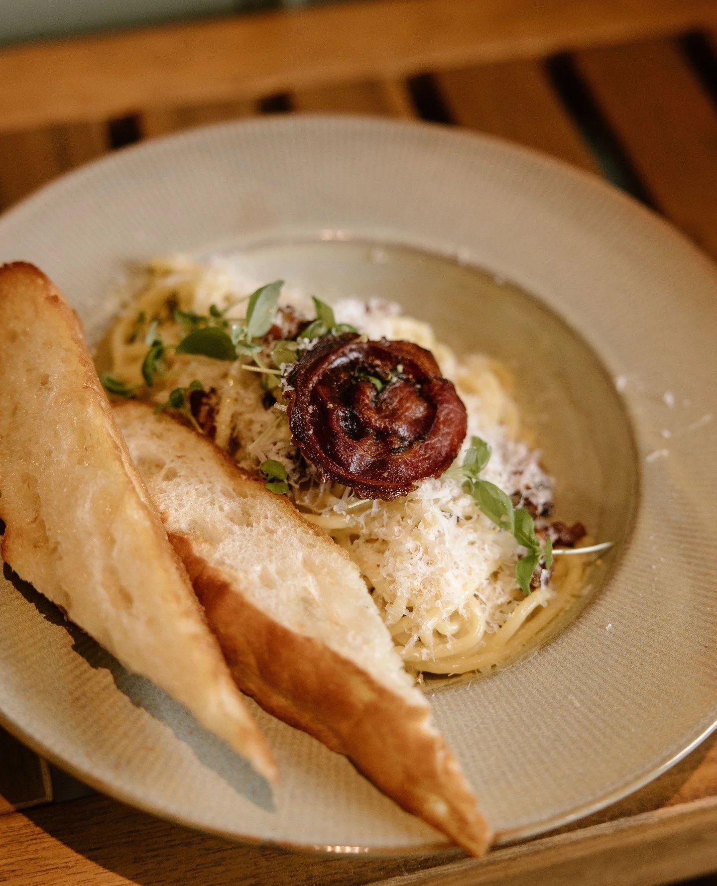 Two weeks in and we&rsquo;re still dreaming about this one. ⁠
Spaghetti Carbonara, silky and savoury, finished with micro basil, a crisp of pancetta, and a warm slice of garlic bread on the side.⁠
⁠
Two weeks left to enjoy this delicious classic. Res