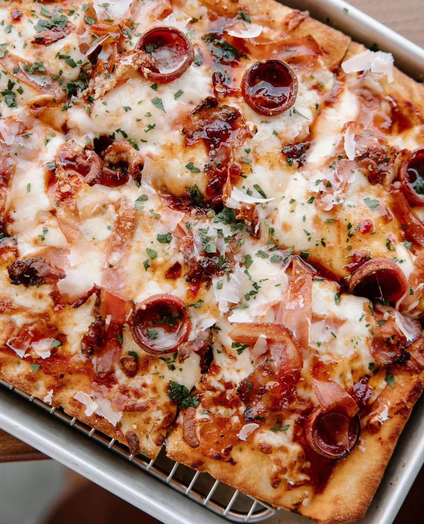 This month&rsquo;s feature Hot Honey Meatlovers Pizza doesn&rsquo;t believe in subtlety.⁠
⁠
Mortadella, pancetta, curled pepperoni, bubbling mozzarella, and rich arrabiata sauce finished with hot honey, basil oil, parsley, and shaved Grana Padano.