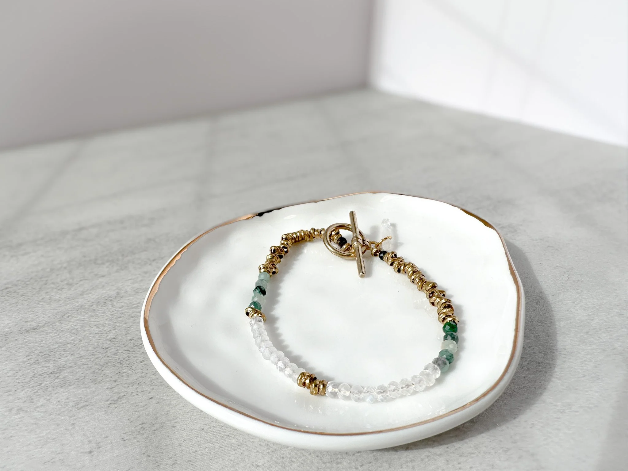 Vesper natural gemstone bracelet on dish, rainbow moonstone, emerald and pietersite beads