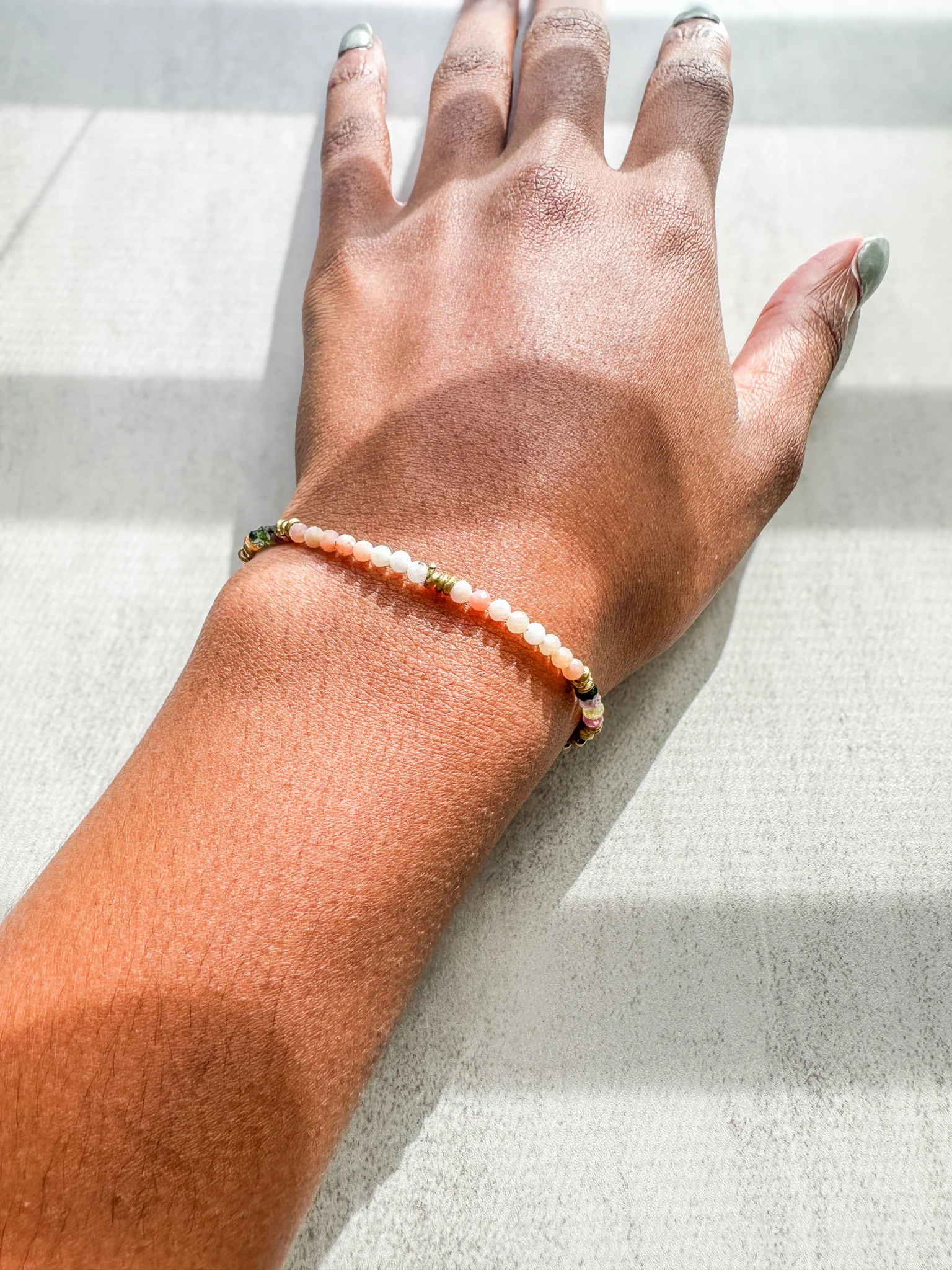 Aurora natural gemstone bracelet on wrist with pink opal, watermelon tourmaline and rainbow moonstone