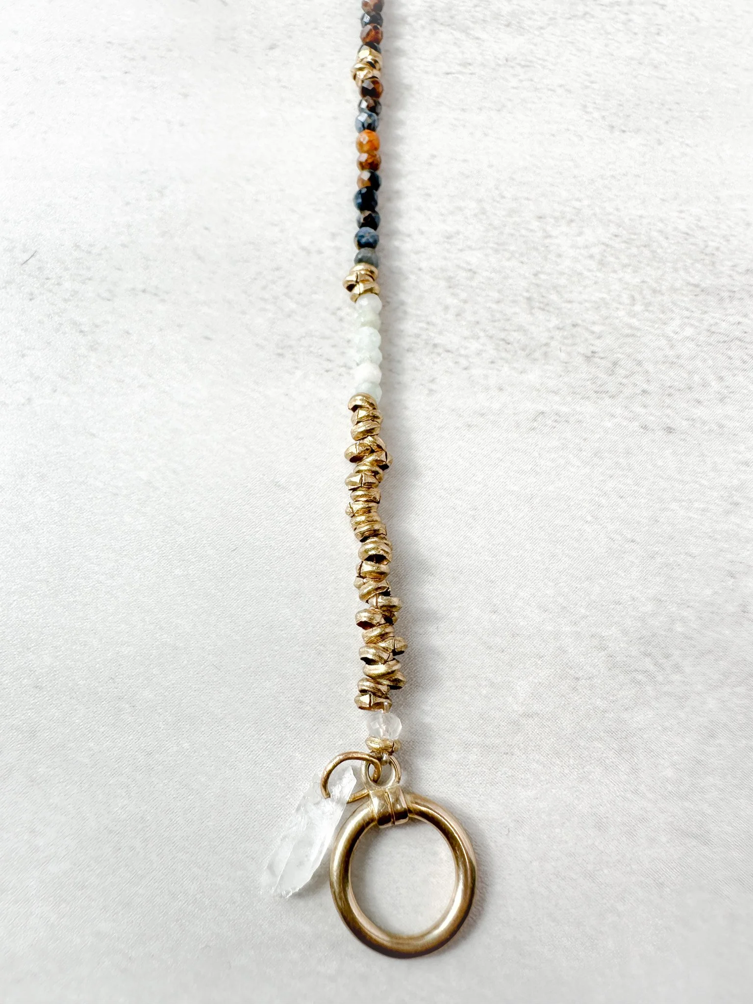 Close-up of Tempest bracelet Ethiopian brass heishi beads and gemstone detail