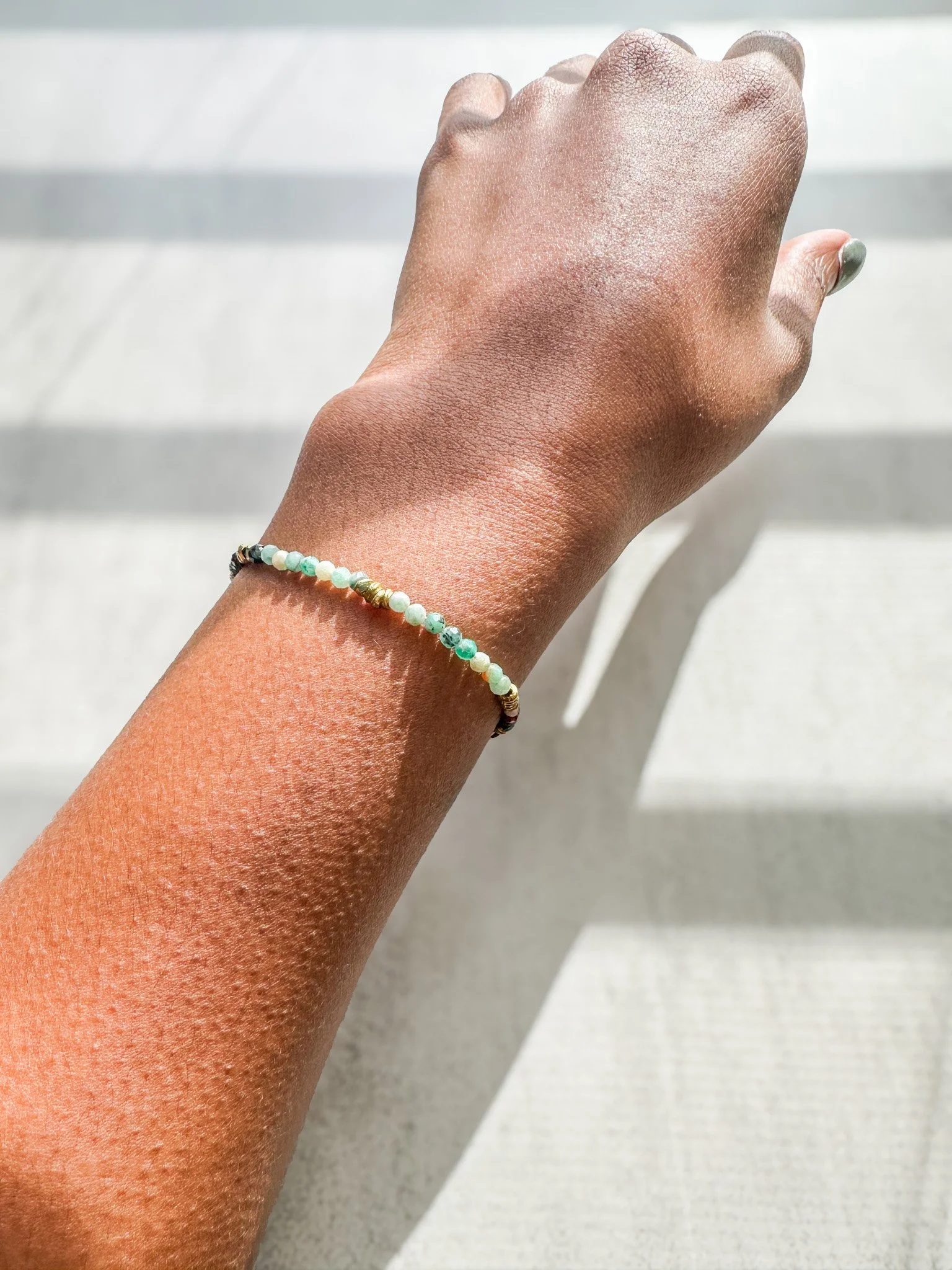 Aether natural gemstone bracelet on wrist in sunlight