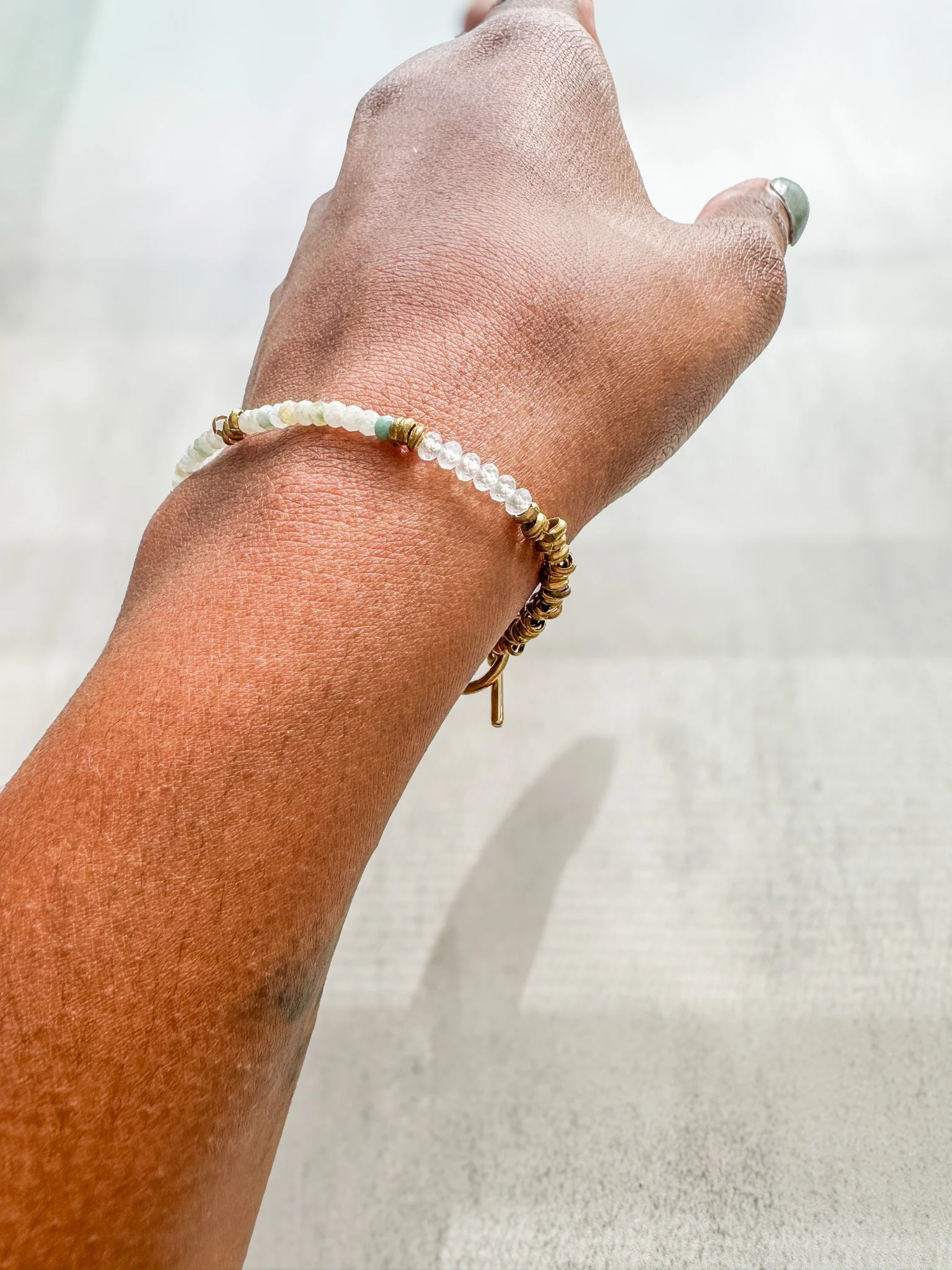 Eden natural gemstone bracelet on wrist in sunlight, close-up of gemstone beads