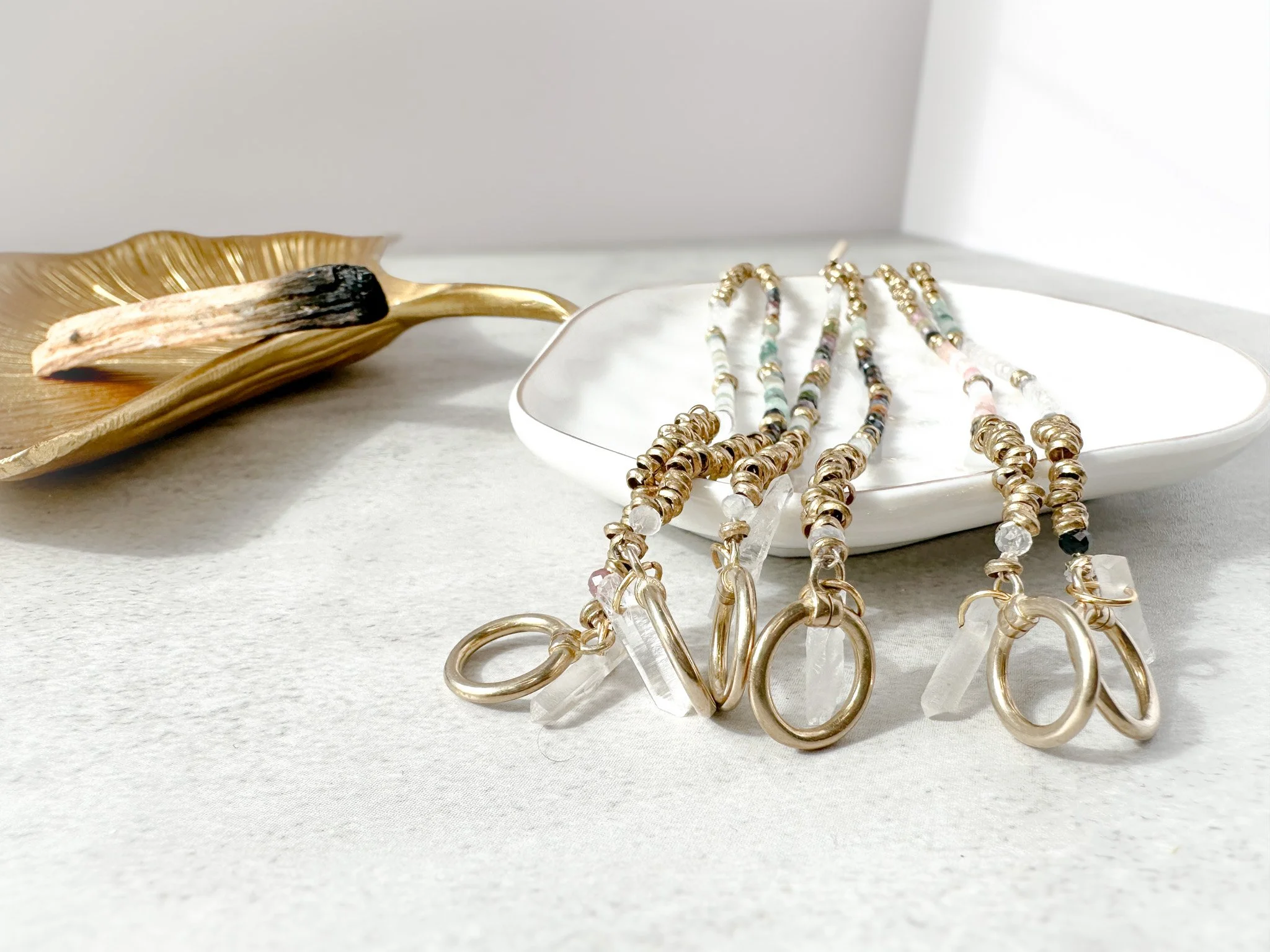 Aether and Embers collection bracelets with toggle clasps and clear quartz charms on dish