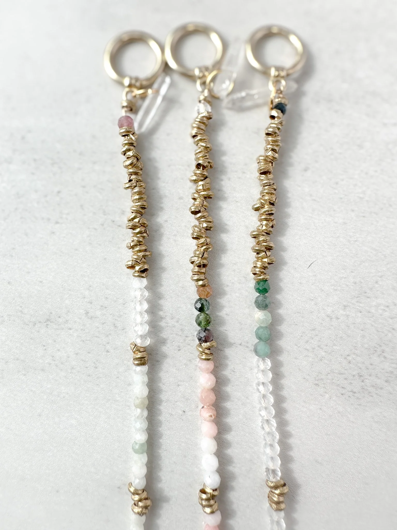 Aether and Embers collection bracelets with brass toggle clasps and clear quartz charms