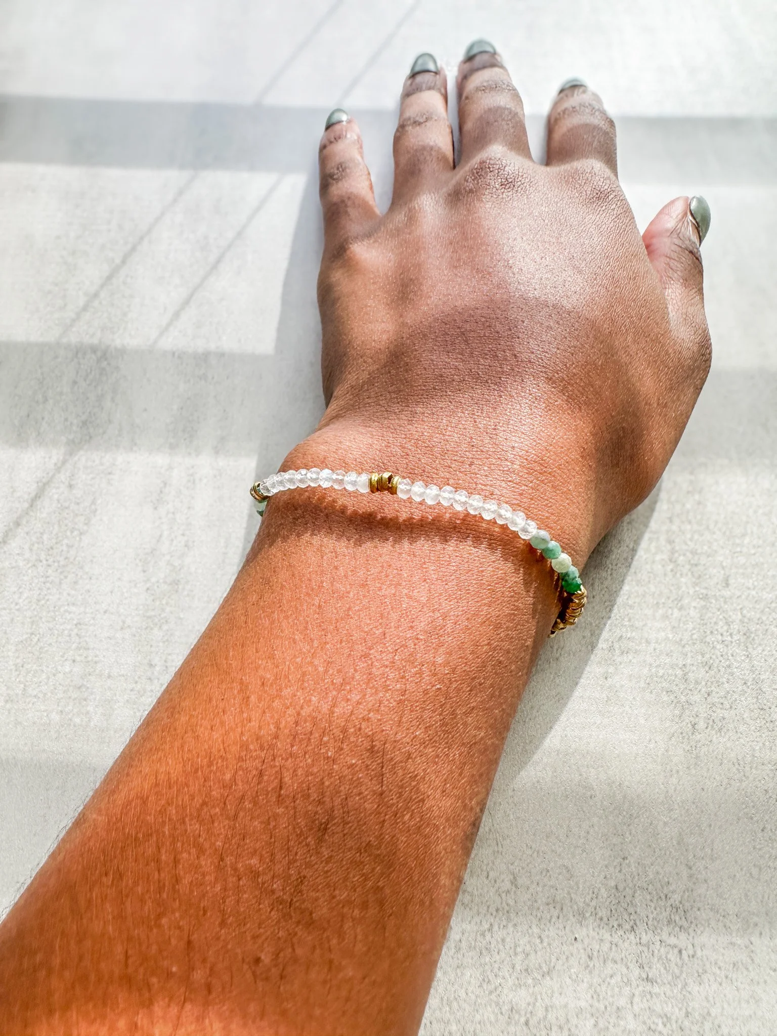 Vesper natural gemstone bracelet on wrist with rainbow moonstone, emerald and pietersite