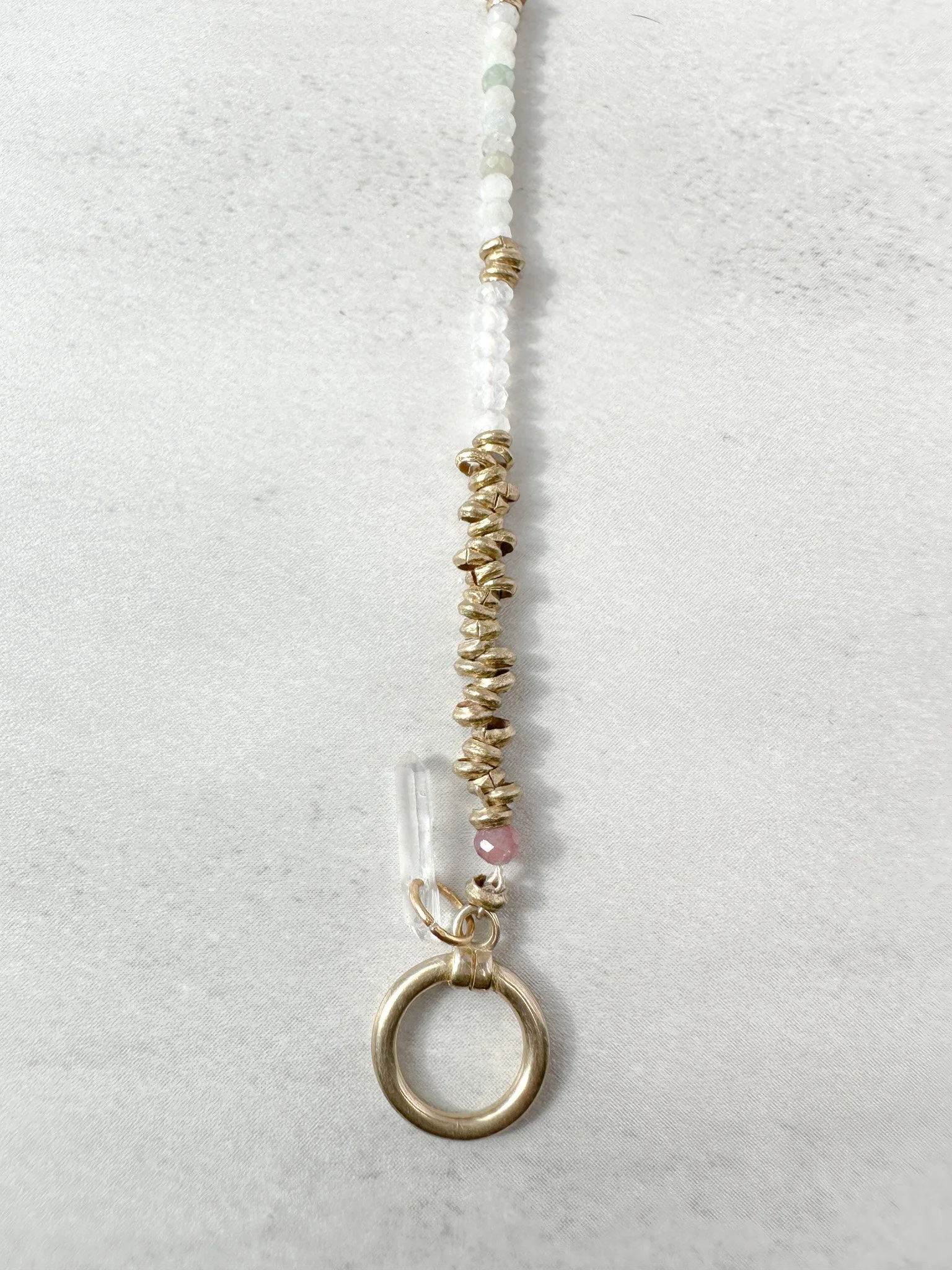 Close-up of Eden bracelet Ethiopian brass heishi beads with toggle clasp and clear quartz charm