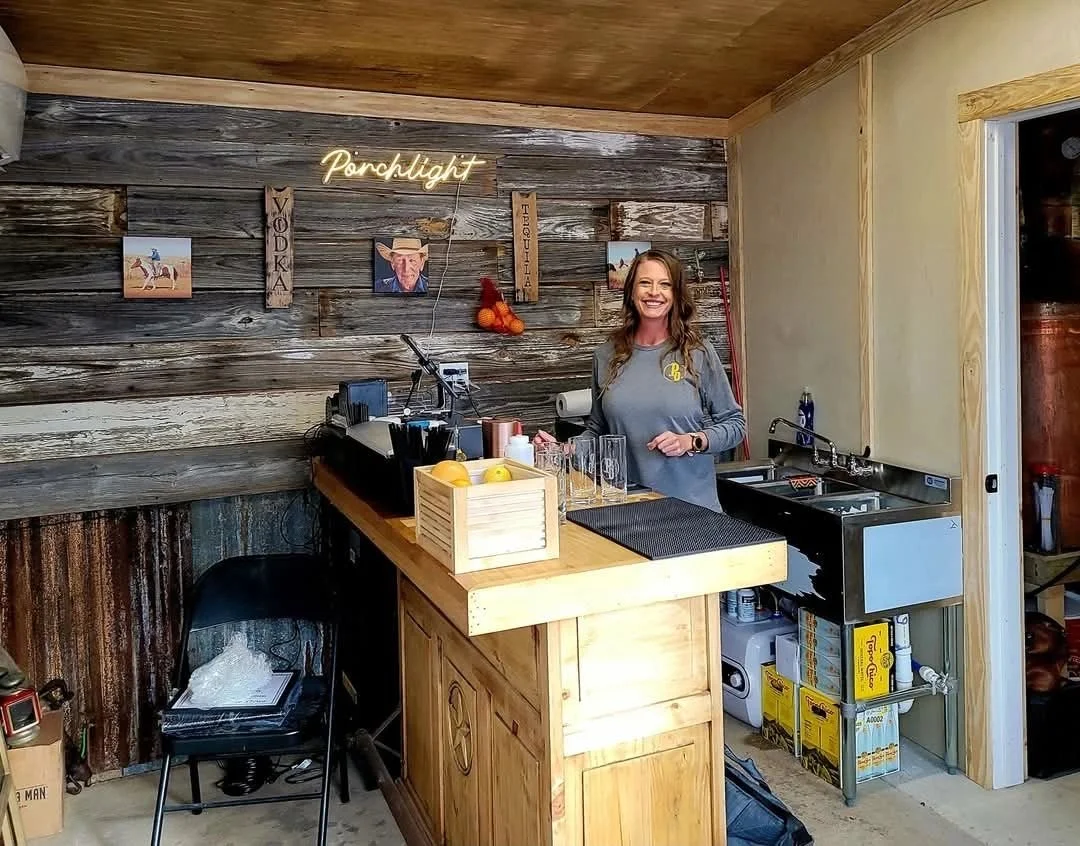 Porchlight Distillery bartender neon bar.jpg