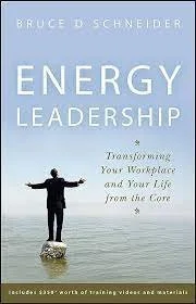 Book cover titled 'Energy Leadership' by Bruce D. Schneider, featuring a person standing on a rock in water with arms outstretched.