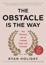 Book cover titled 'The Obstacle Is The Way' by Ryan Holiday, featuring a laurel wreath around the subtitle and a quote about turning trials into triumph.