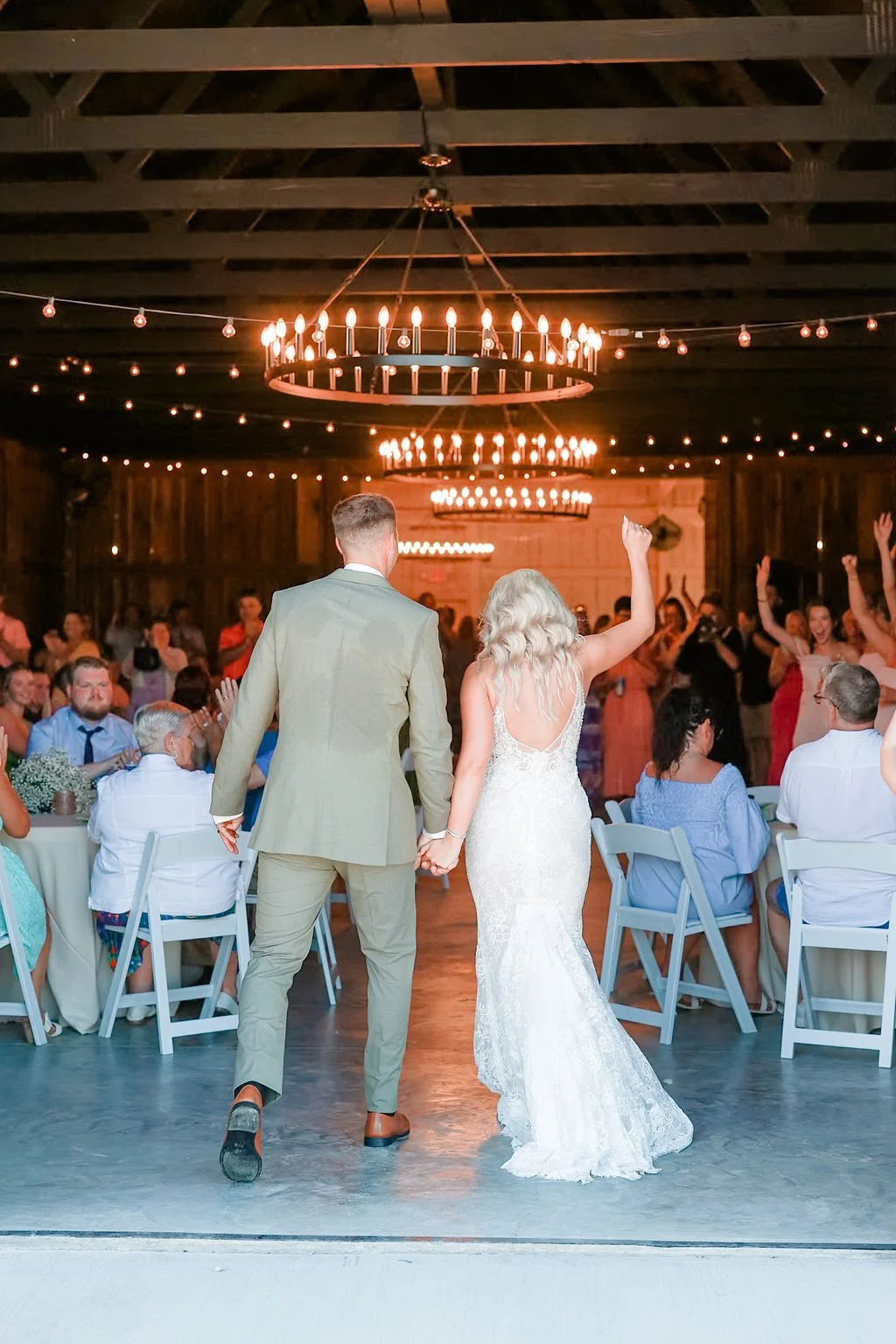 Bride and groom entering wedding reception after outdoor Kentucky ceremony