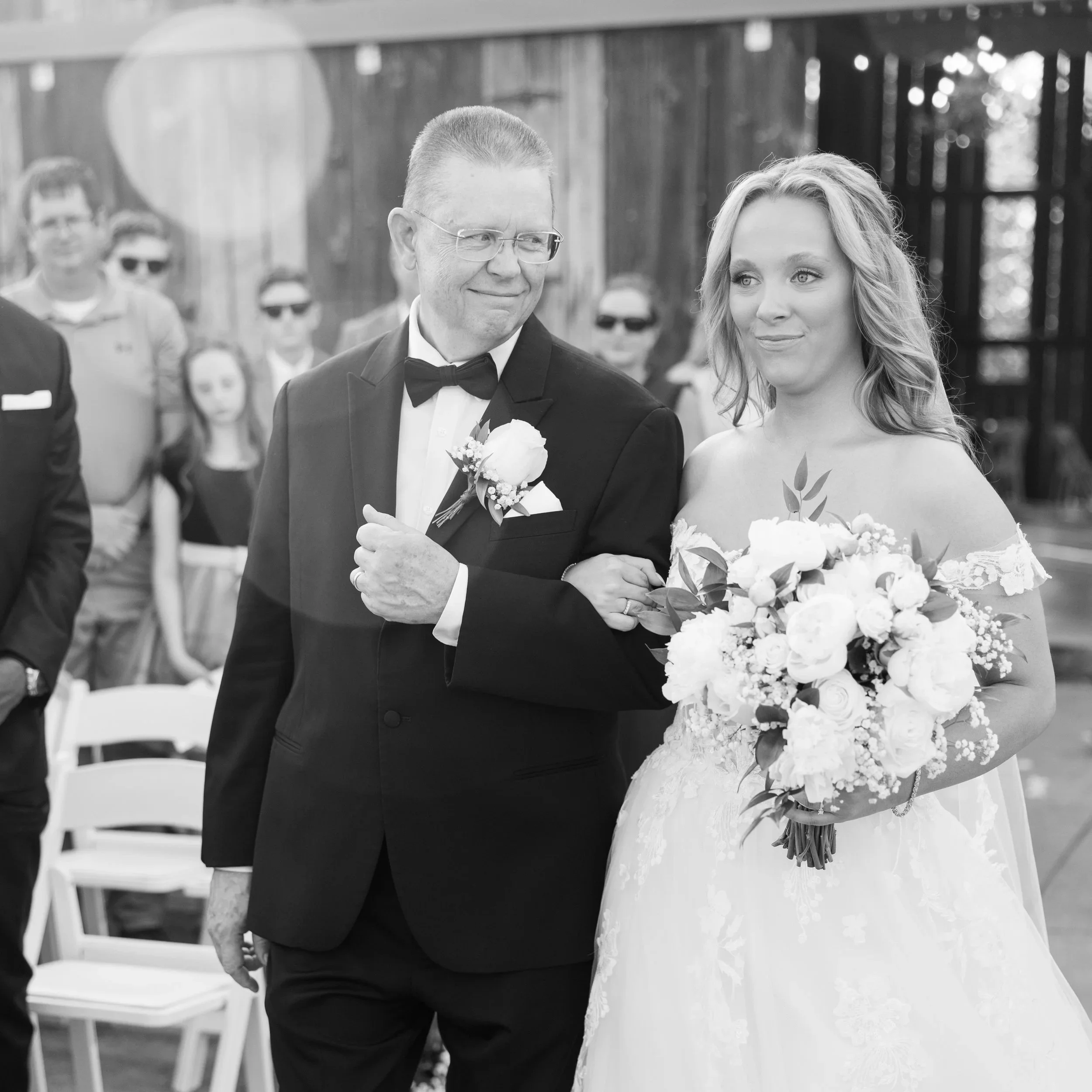 Bride walking down the aisle with her father at a Kentucky barn wedding