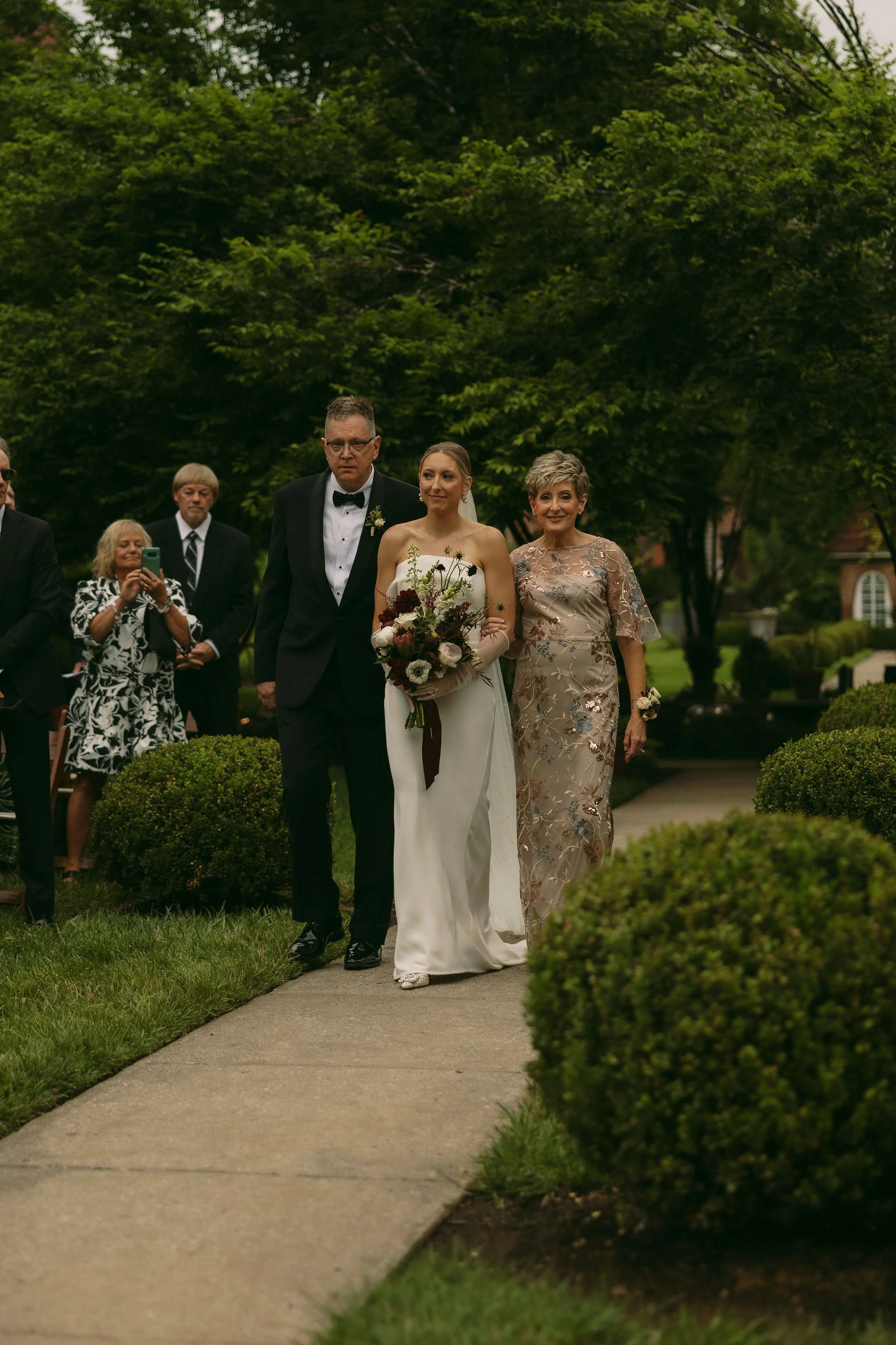 Bride and parents walking down the aisle at Castle and Key