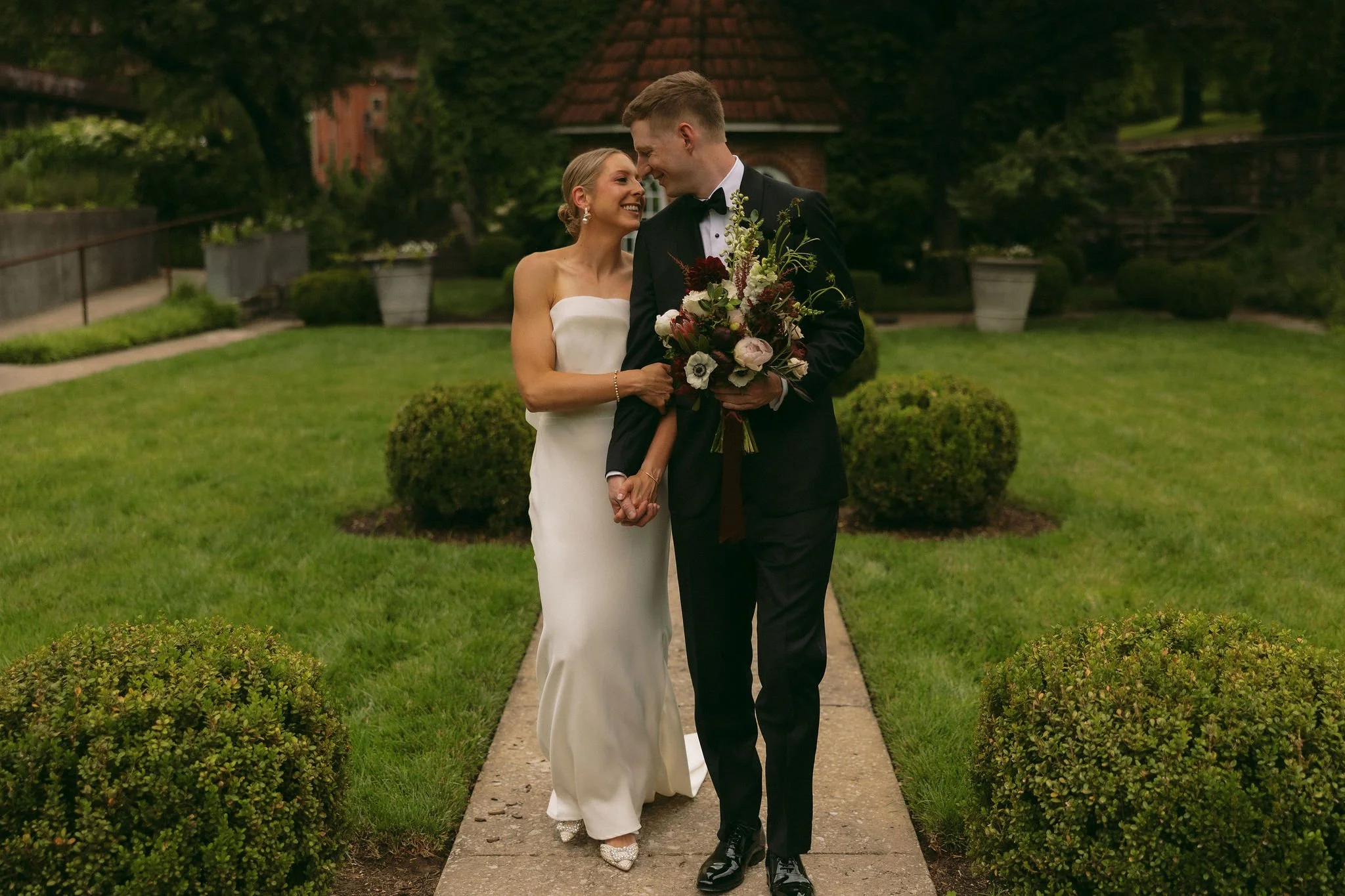 Bride and groom walking through Castle & Key grounds