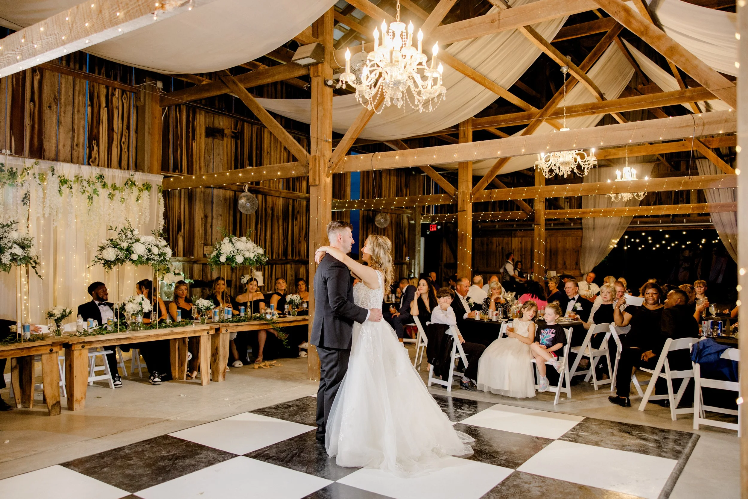 Bride and groom first dance at a black and white Kentucky barn wedding reception