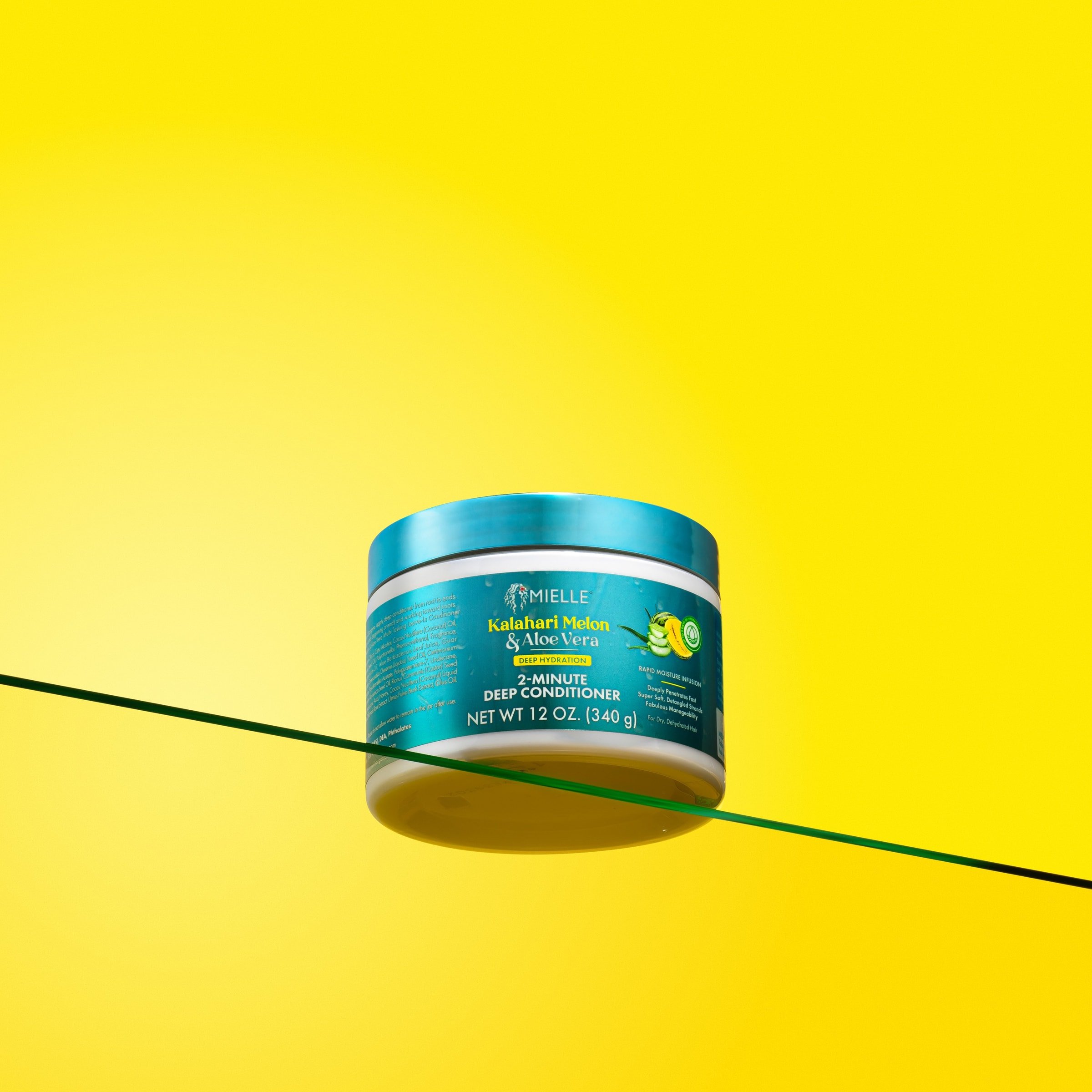 Mielle Kalahari Melon & Aloe Vera deep conditioner on yellow background.
