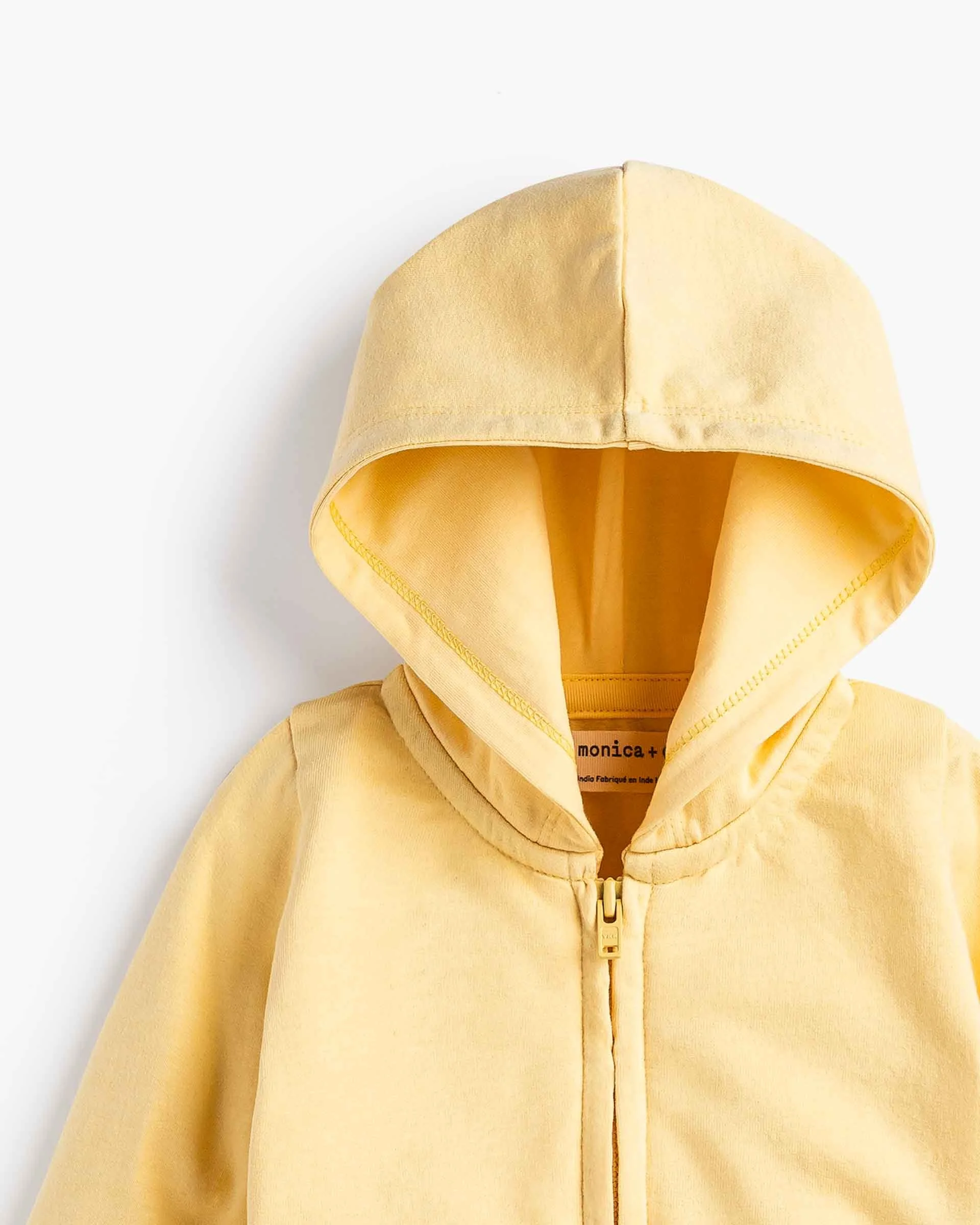 Yellow hoodie with zipper, hood up, against a white background.