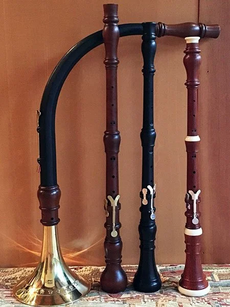 An assortment of 4 double-reed instruments standing on a table